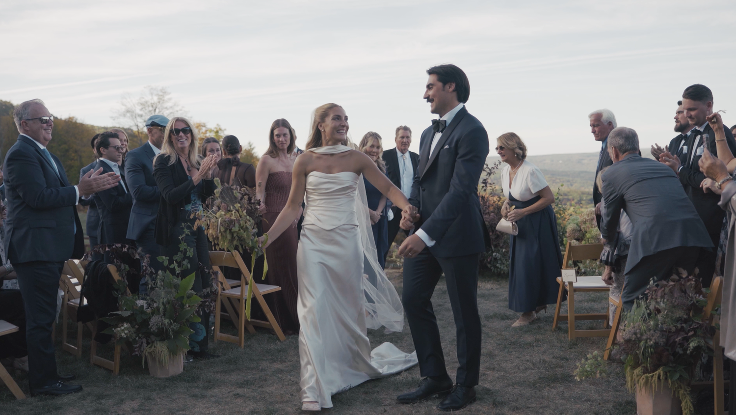 Bride and groom embracing during outdoor wedding ceremony in Hudson Valley New York Area captured in documentary film style