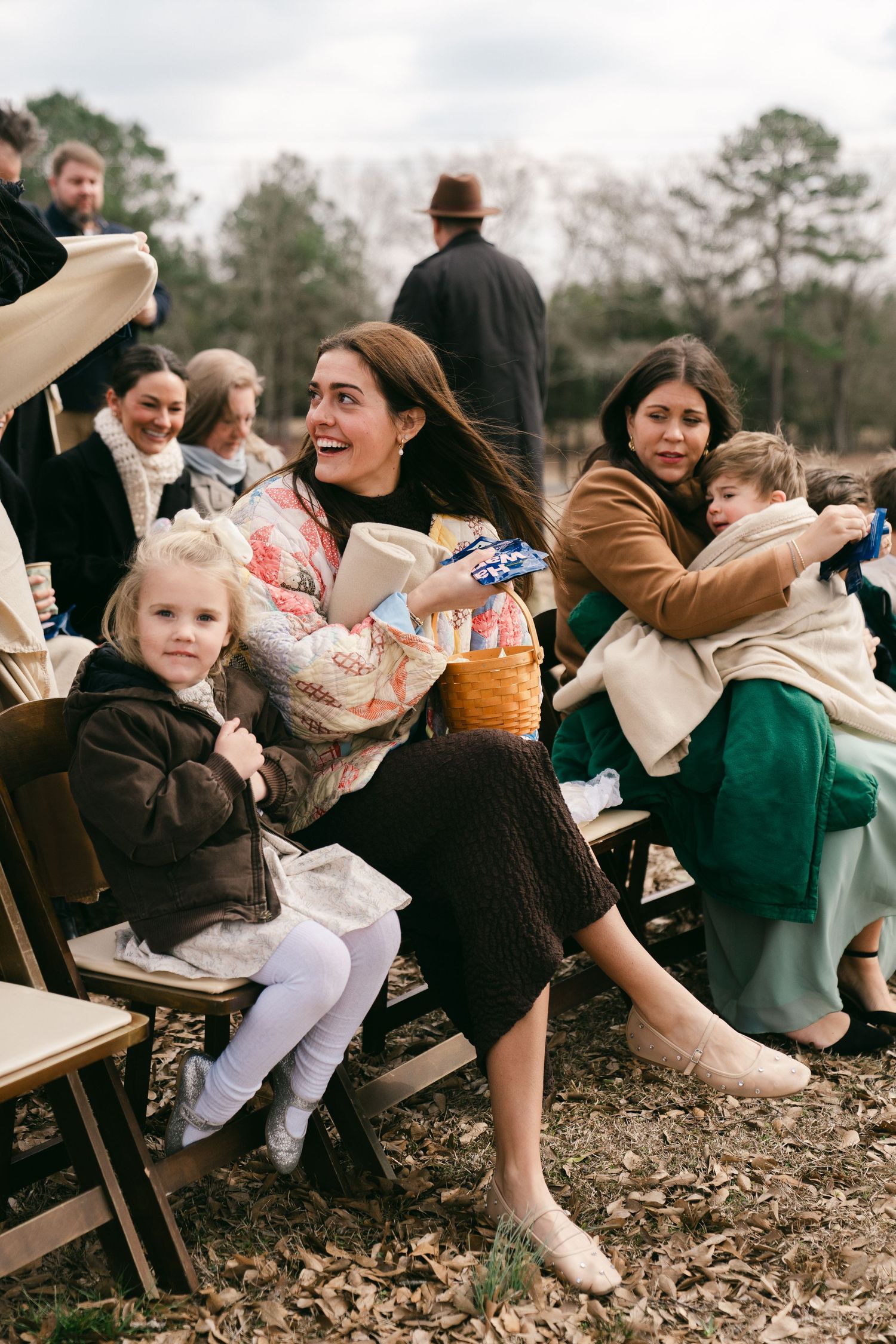 Family embracing during outside winter wedding ceremony in Birmingham AL captured in documentary film style