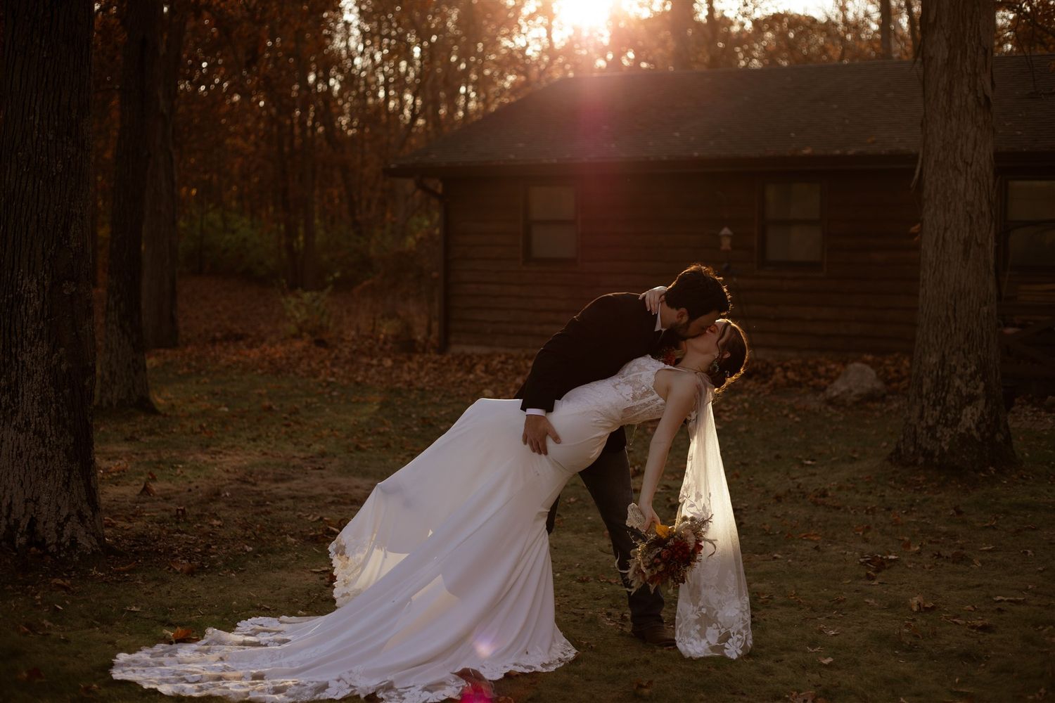 Wedding photography in progress during sunset in an autumn forest setting.