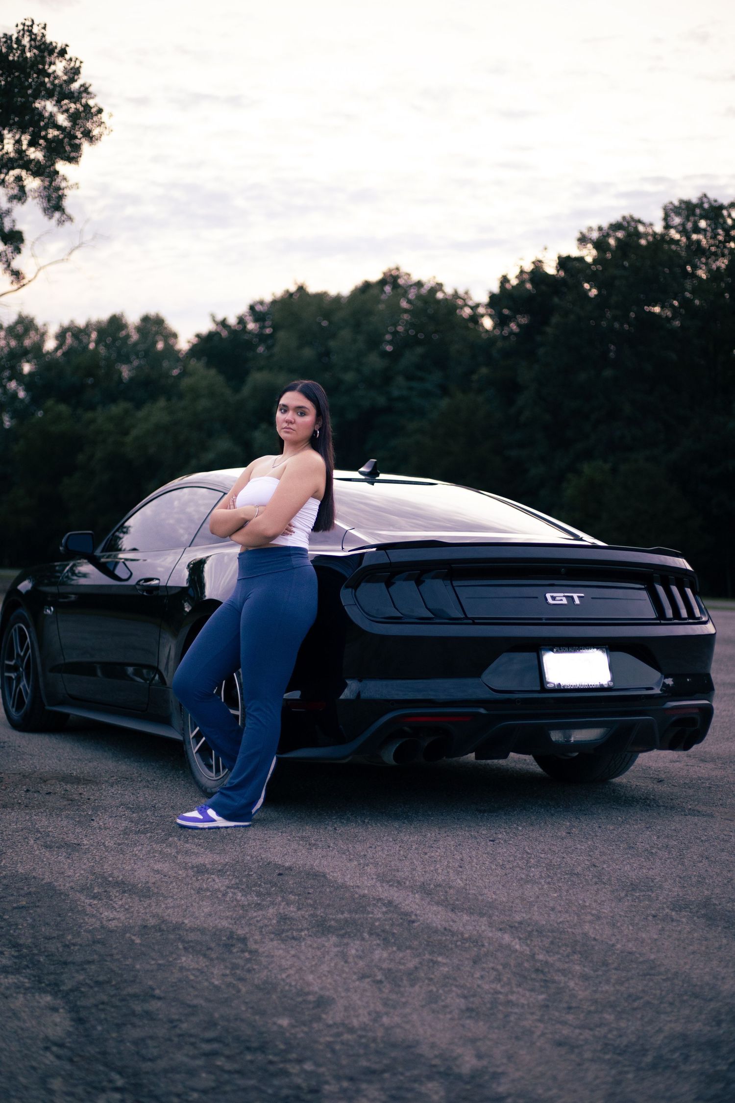 Classic black car photographed at sunset with artistic poses.