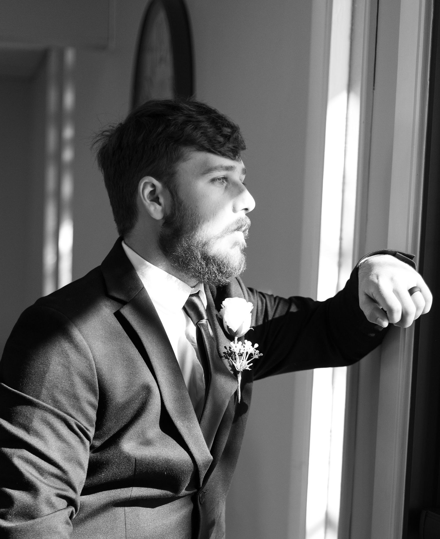 Black and white photo sequence showing a bearded person in a suit jacket looking to the side in dramatic lighting.