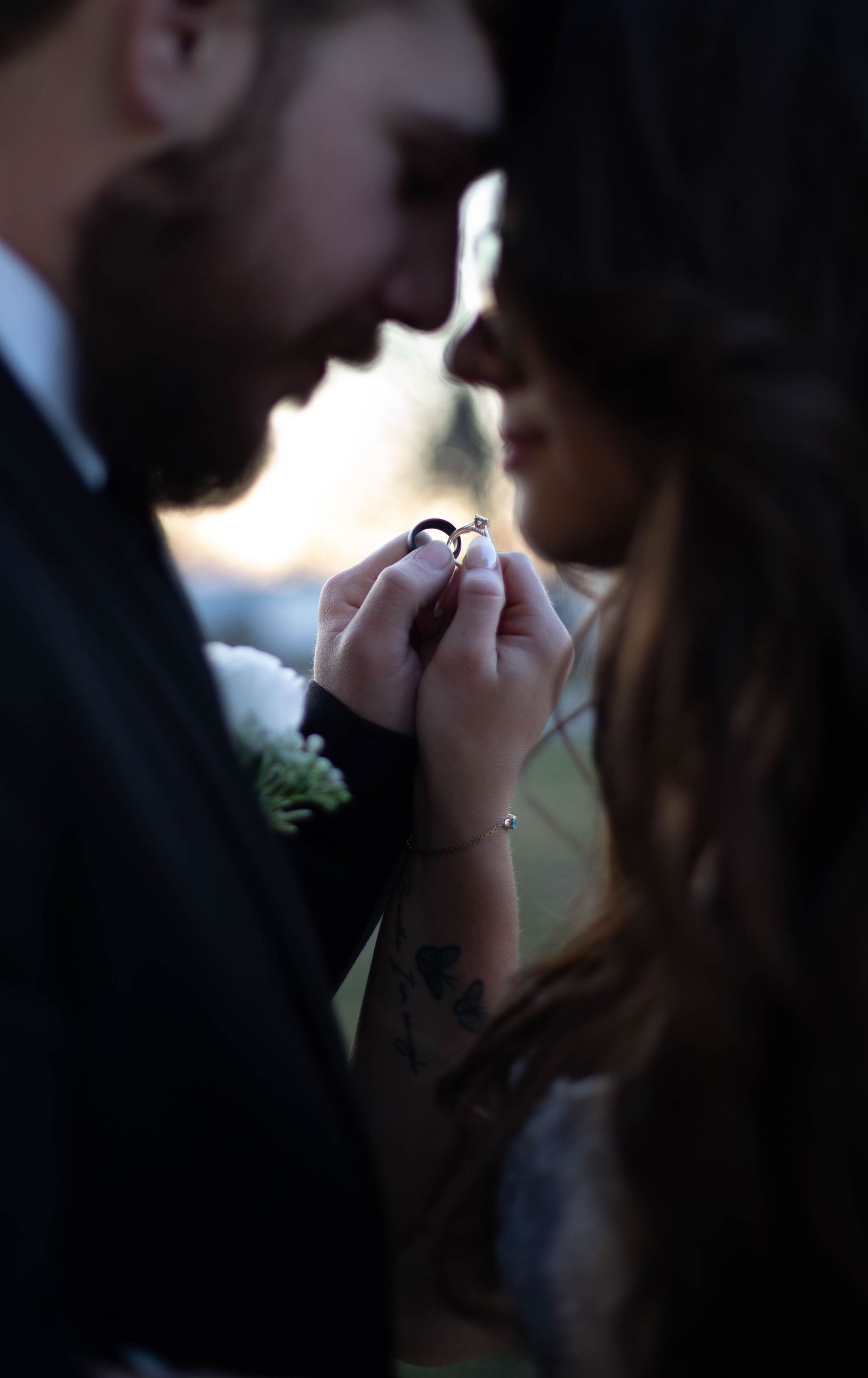 Silhouetted couple in intimate moment during romantic photoshoot.