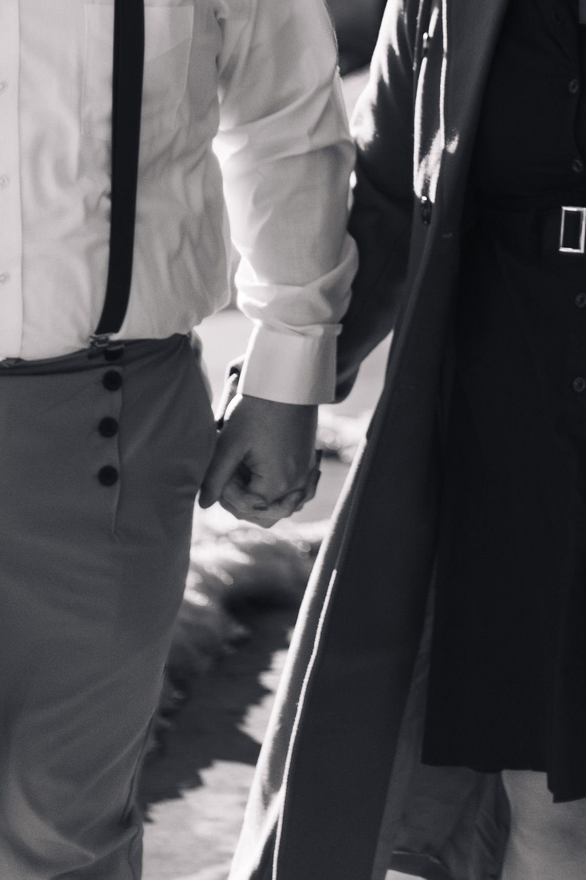 A row of formal black and white attire shown from waist level in an artistic composition.