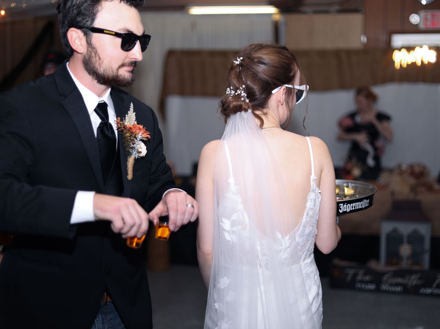 Wedding reception scene with dancing guests in formal attire.