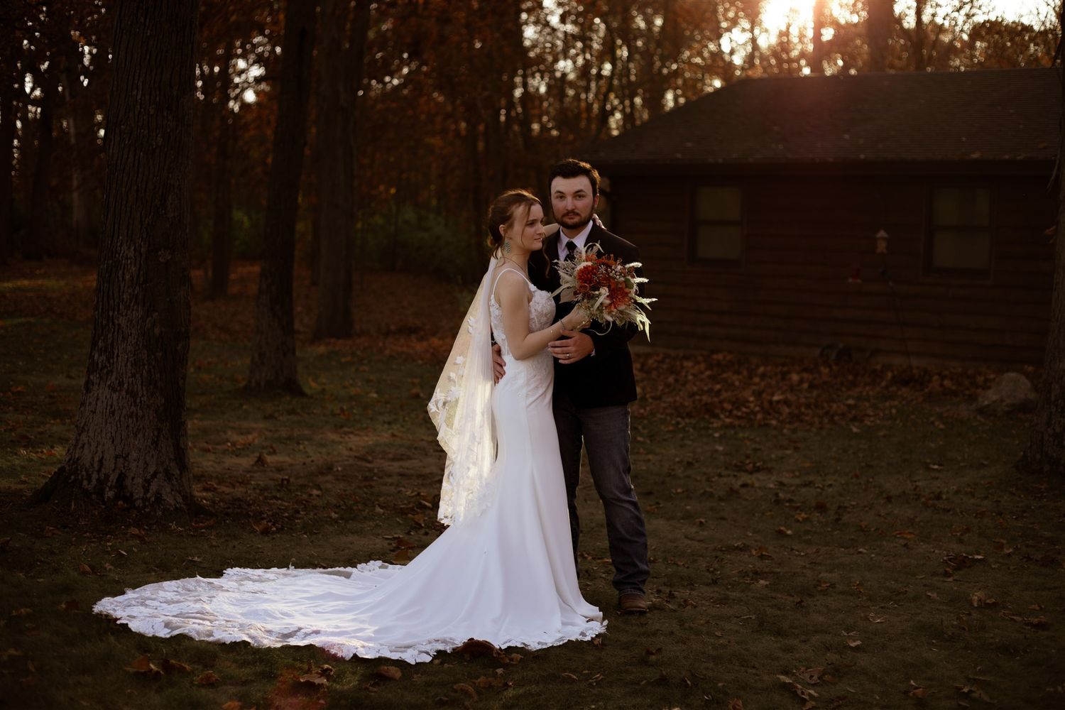 Wedding photography session in a forest with dramatic sunset lighting.