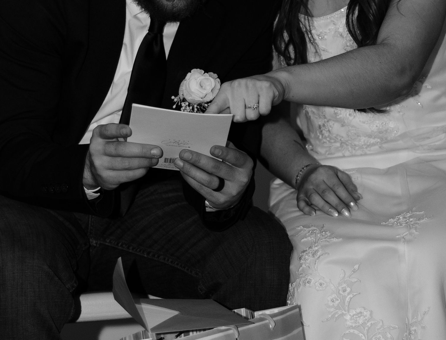 A close-up series of hands signing a document with a pen at what appears to be a formal ceremony or event.