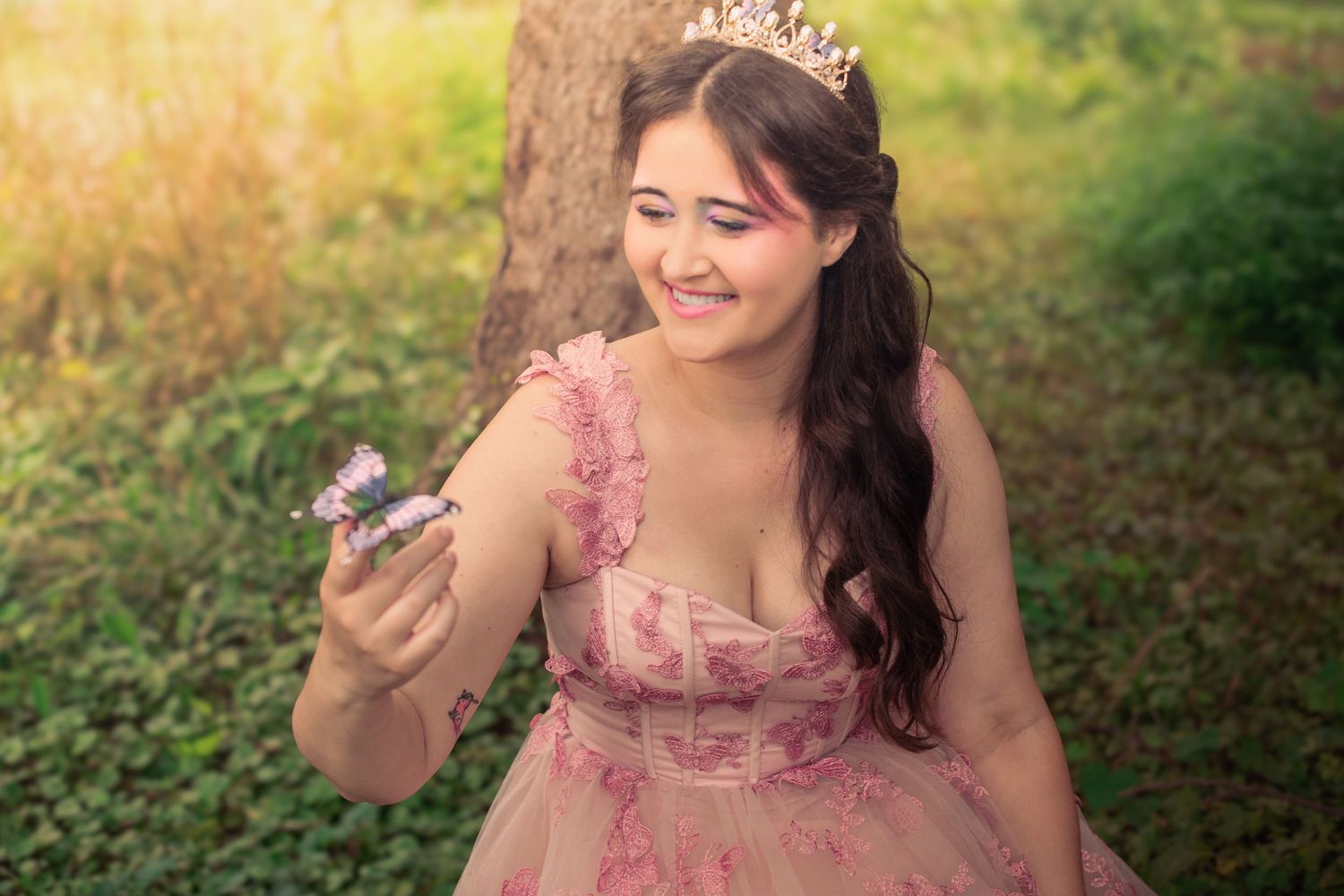 A series of four photos showing someone in a pink dress posing playfully in a sunlit outdoor setting.