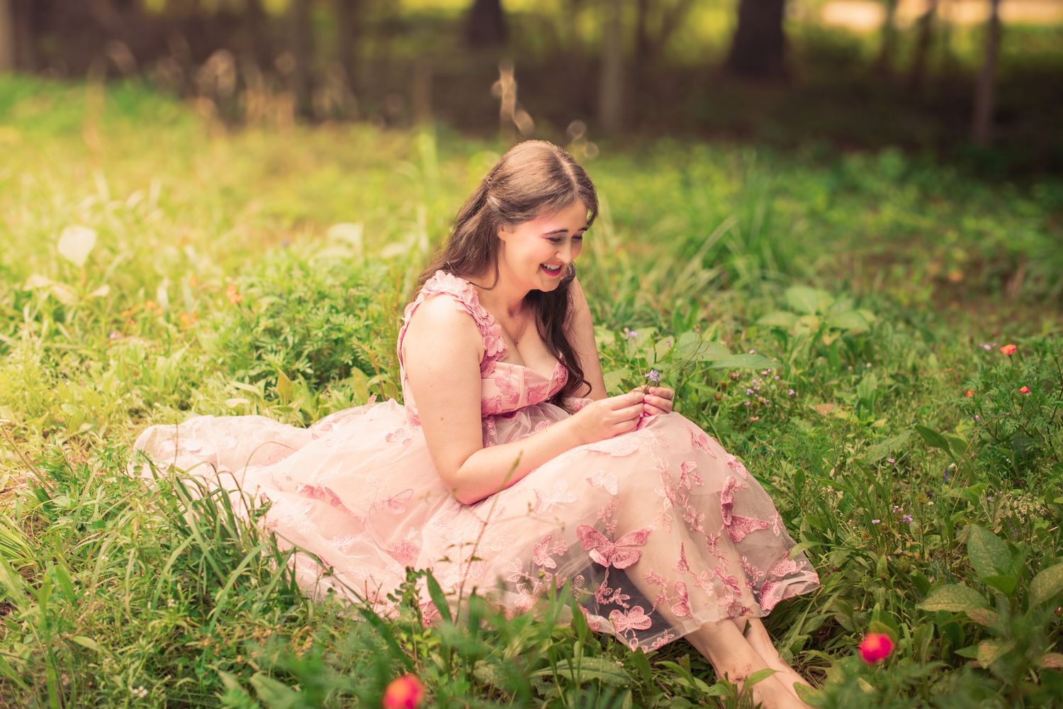 Enchanting garden photoshoot featuring a pink tulle gown and natural surroundings.