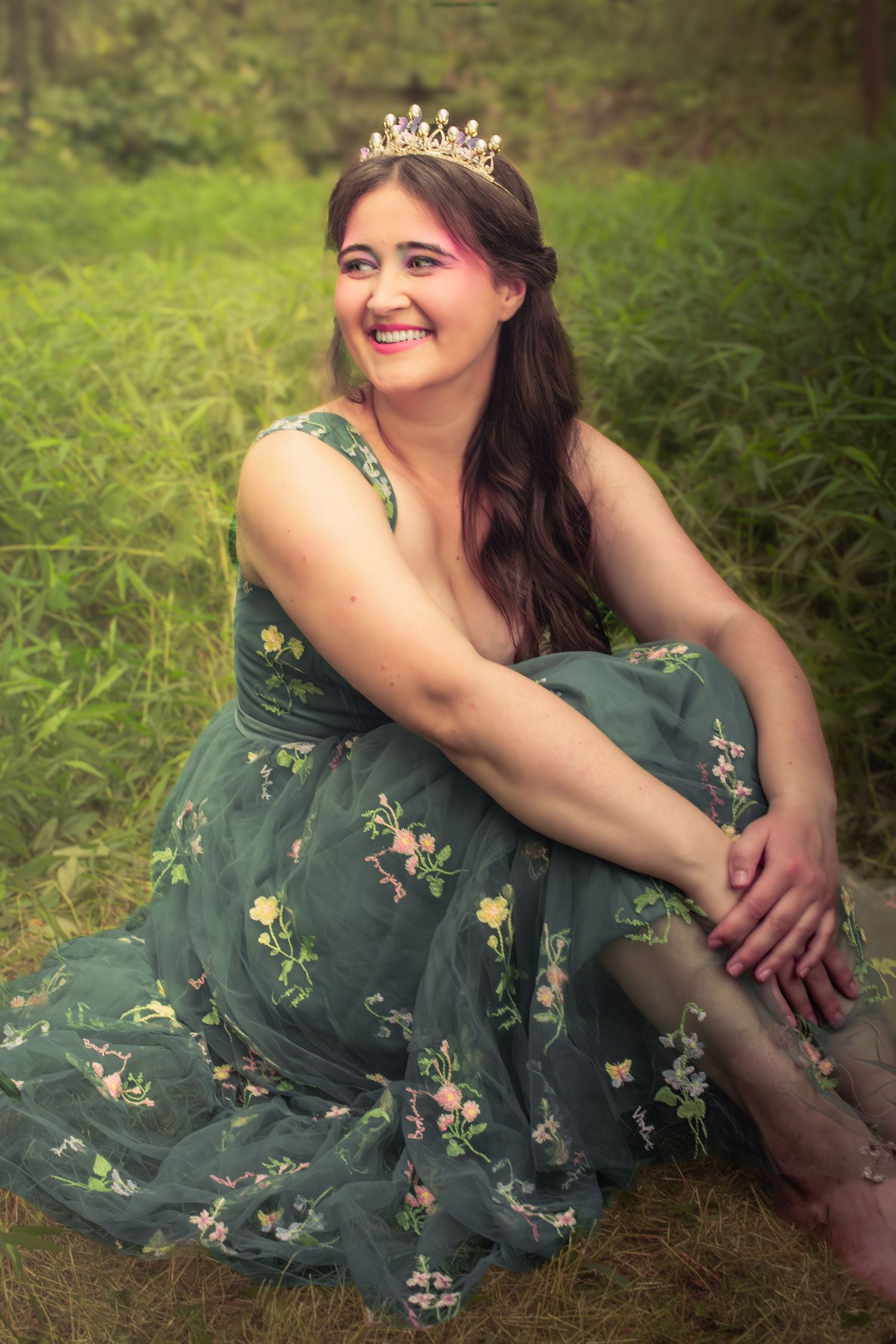 Forest photography session showcasing a green floral dress and delicate crown.