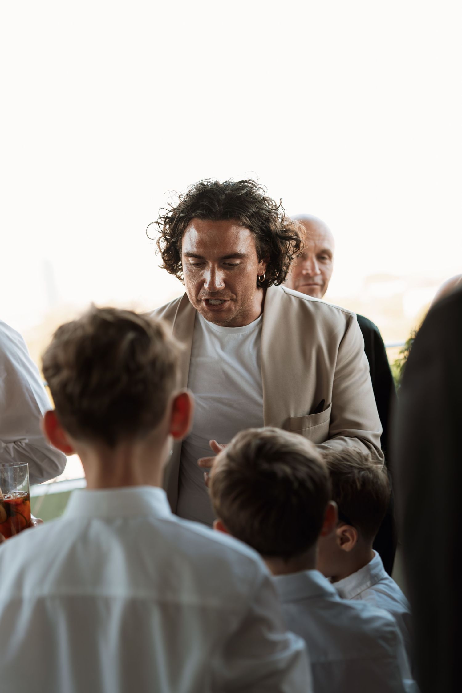 Group of people in white shirts gather together at an event.