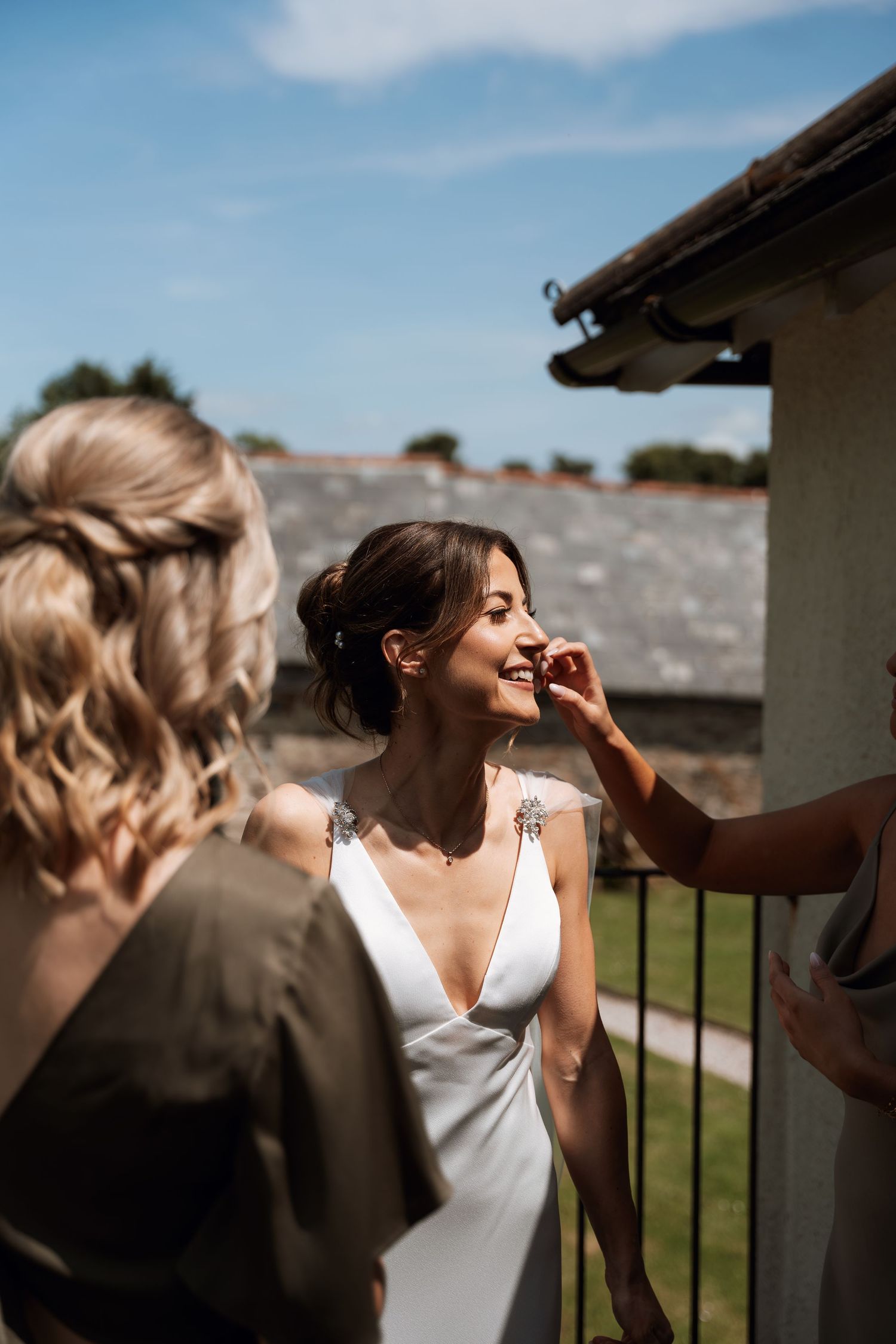 A series of wedding preparation photos showing makeup application in warm outdoor lighting.