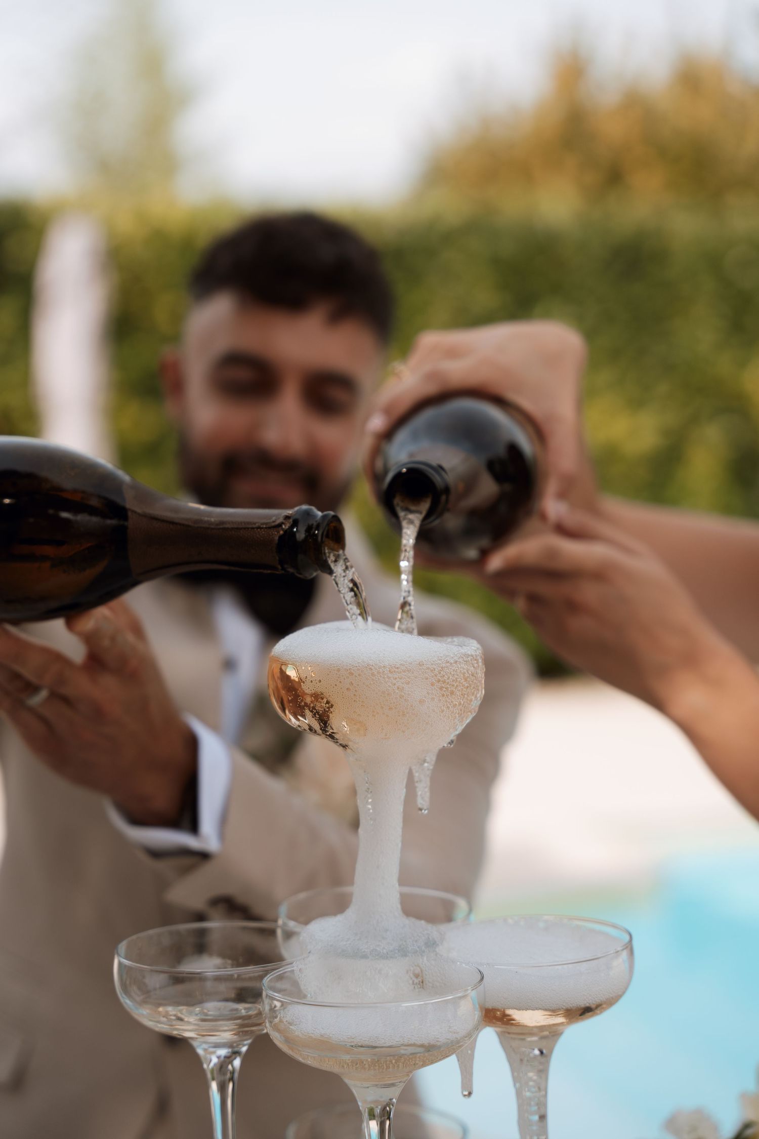 Champagne being poured into elegant glasses creating a celebratory splash.