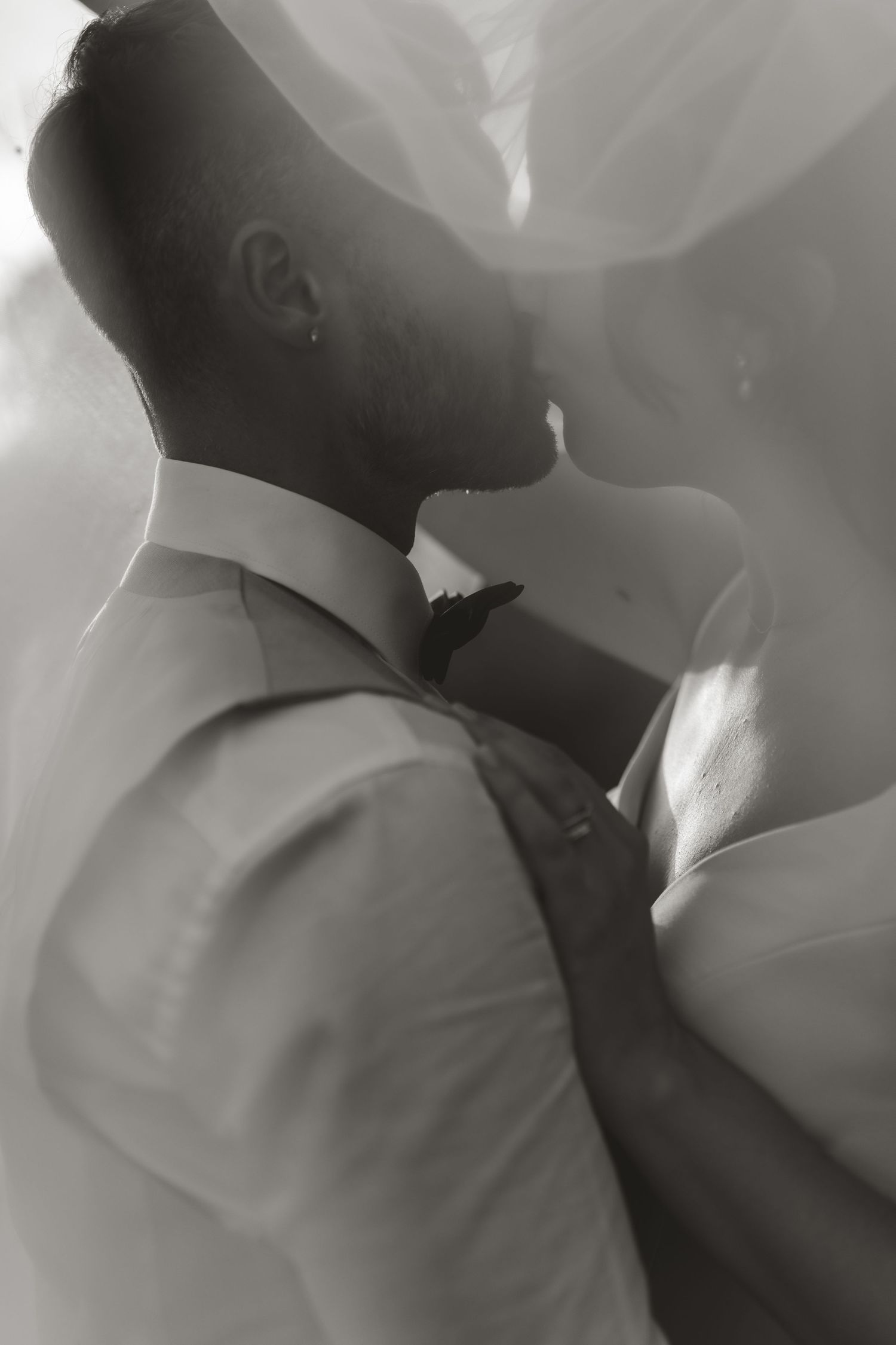 A romantic black and white photo series showing an intimate moment between a couple in formal attire.
