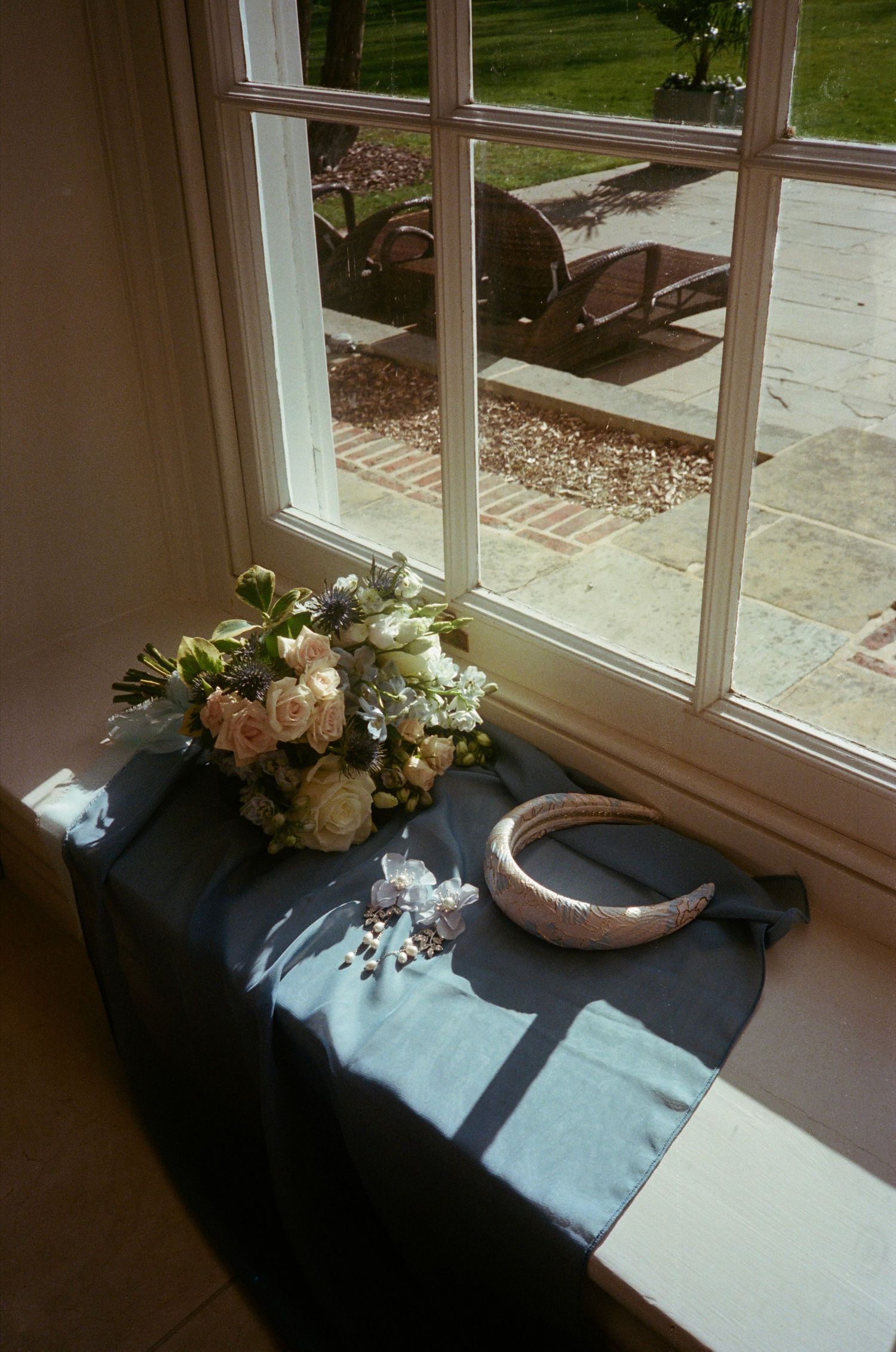 A sequence of floral arrangements on a windowsill shows the progression of natural sunlight throughout the day.