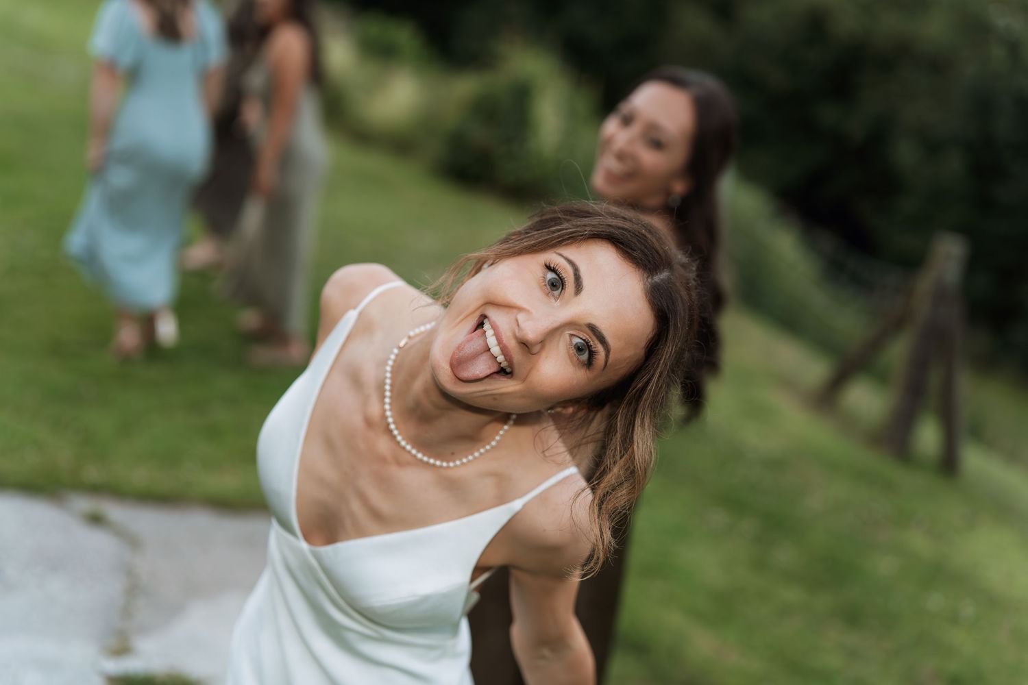 Wedding celebration in a lush green outdoor garden setting.