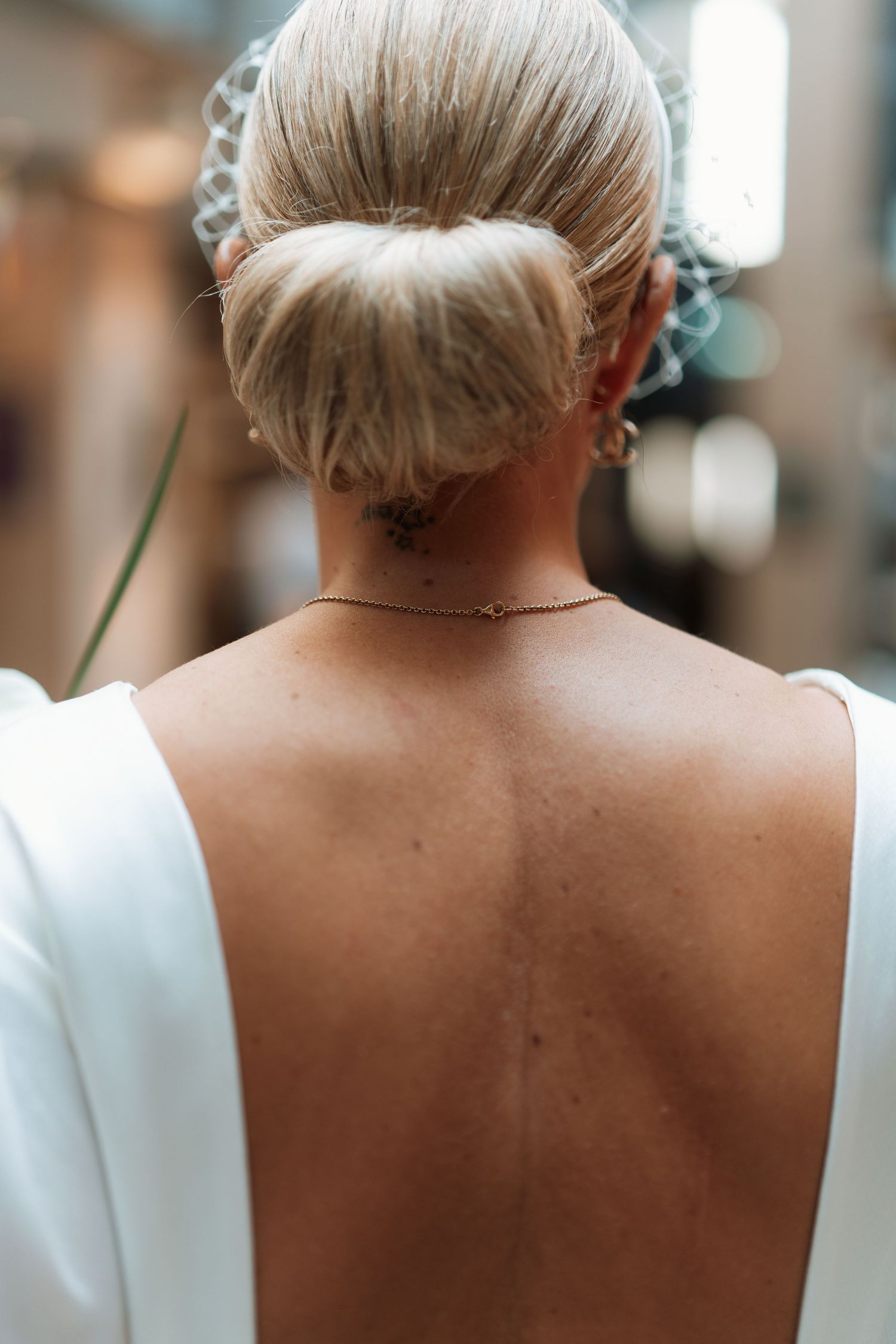 Close-up view of a bride's elegant updo hairstyle with delicate details shown from multiple angles.