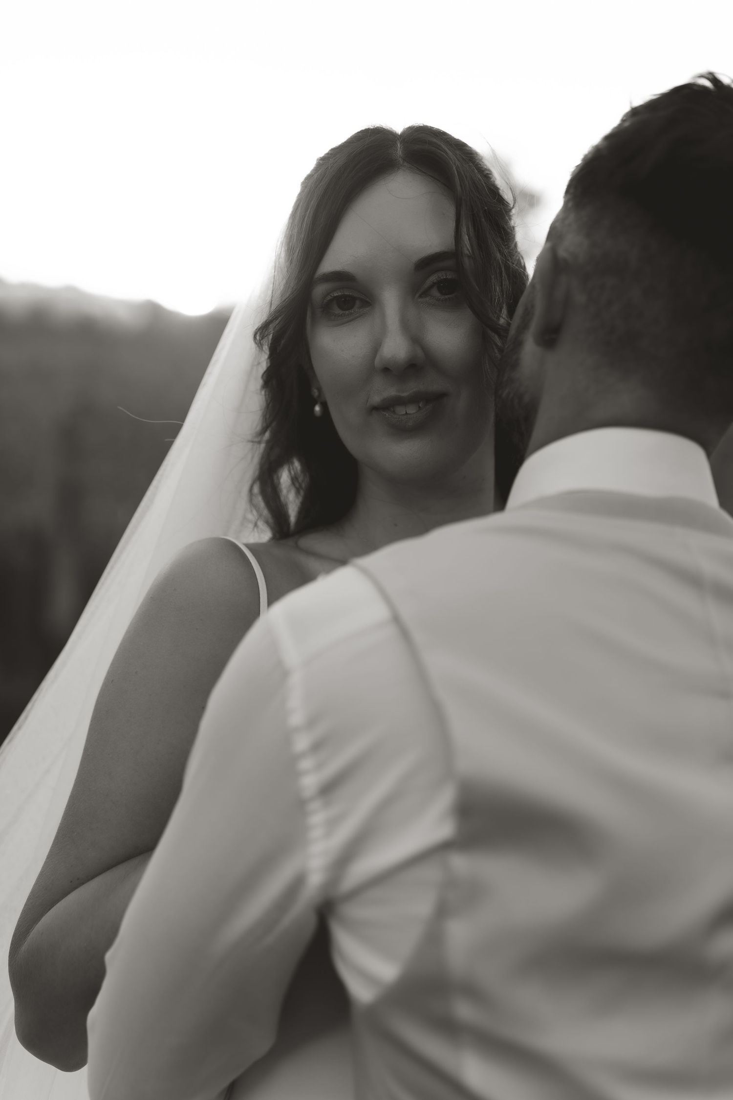 Black and white artistic portrait of a couple during their wedding celebration.