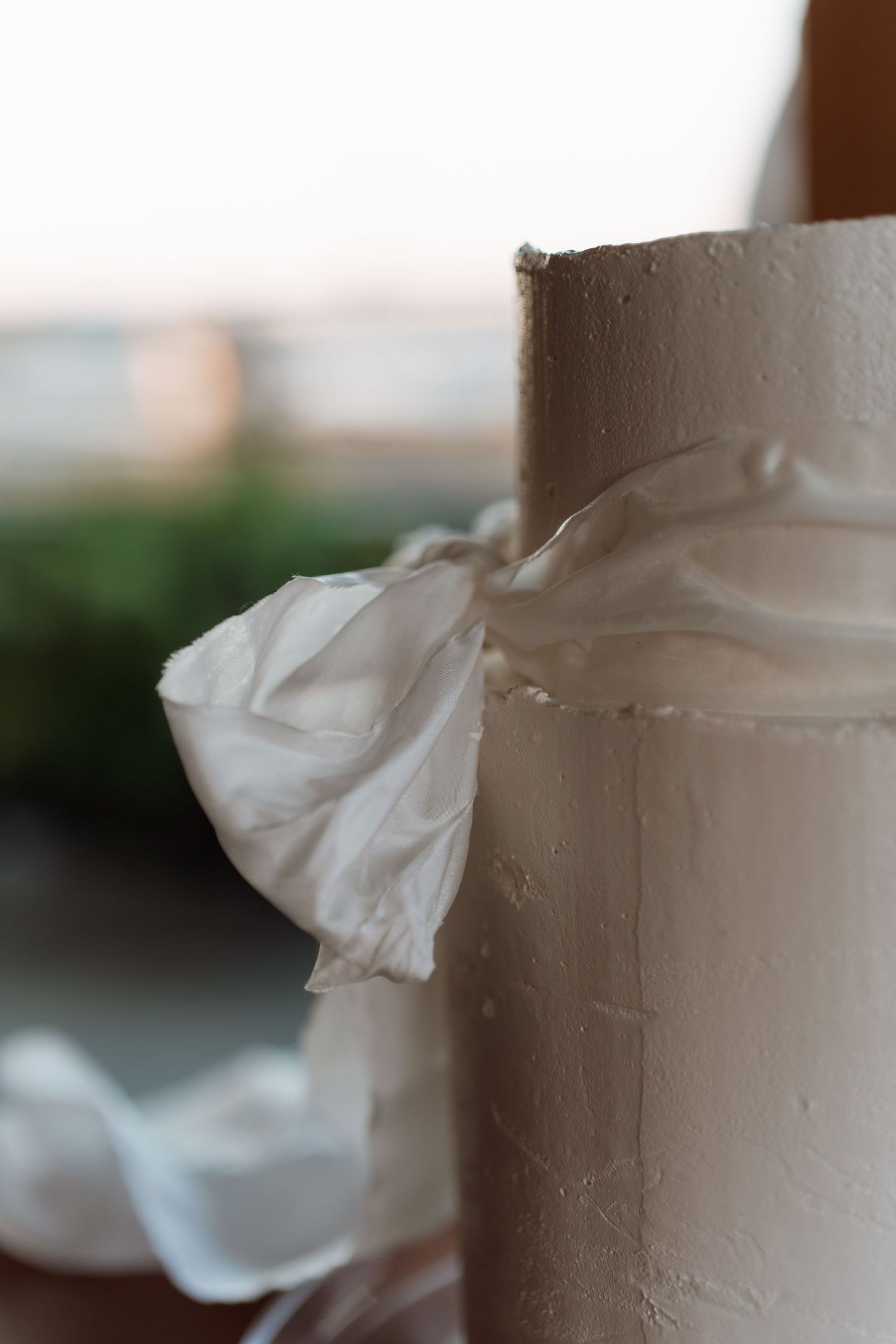 Close-up detail of white textured wedding cake frosting.