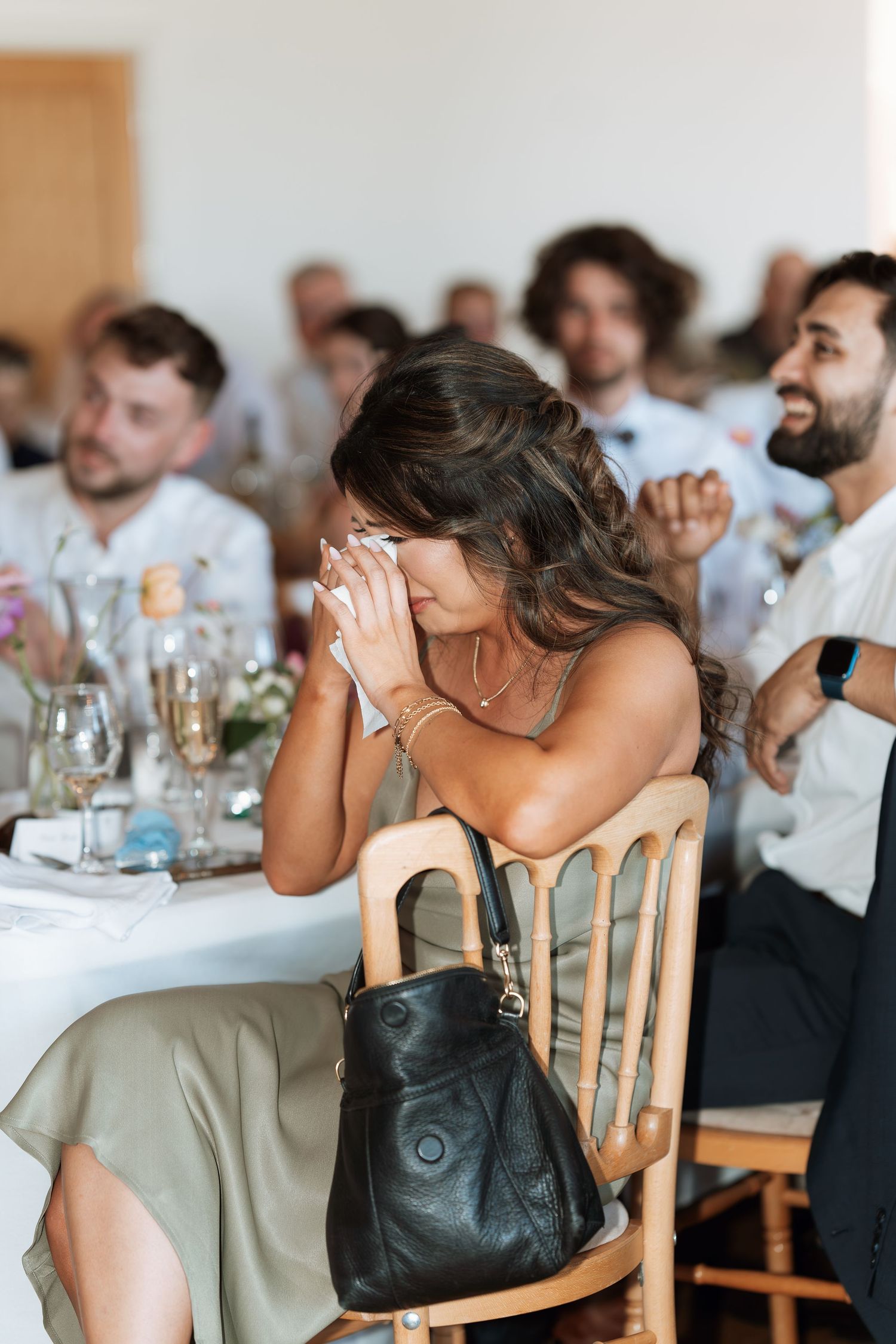 A sequence of emotional reactions during what appears to be a wedding reception at a dining table.