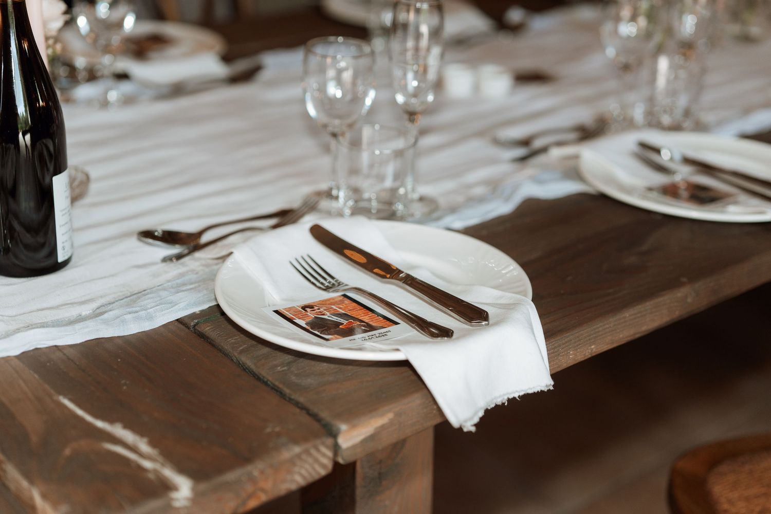 Elegant table settings with wine glasses and cutlery arranged for a wedding reception.