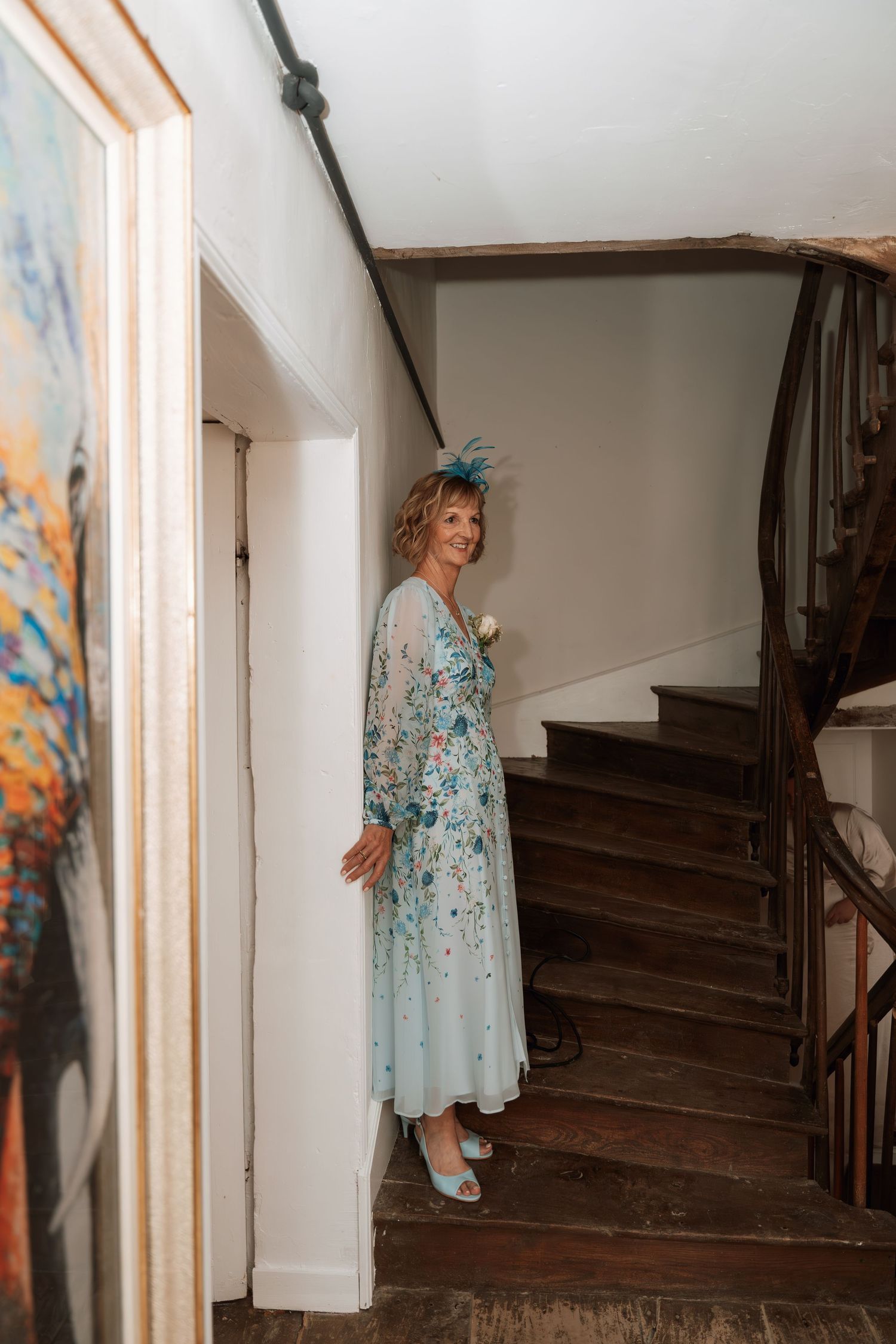 Sequence showing someone ascending wooden stairs in a flowing blue dress.