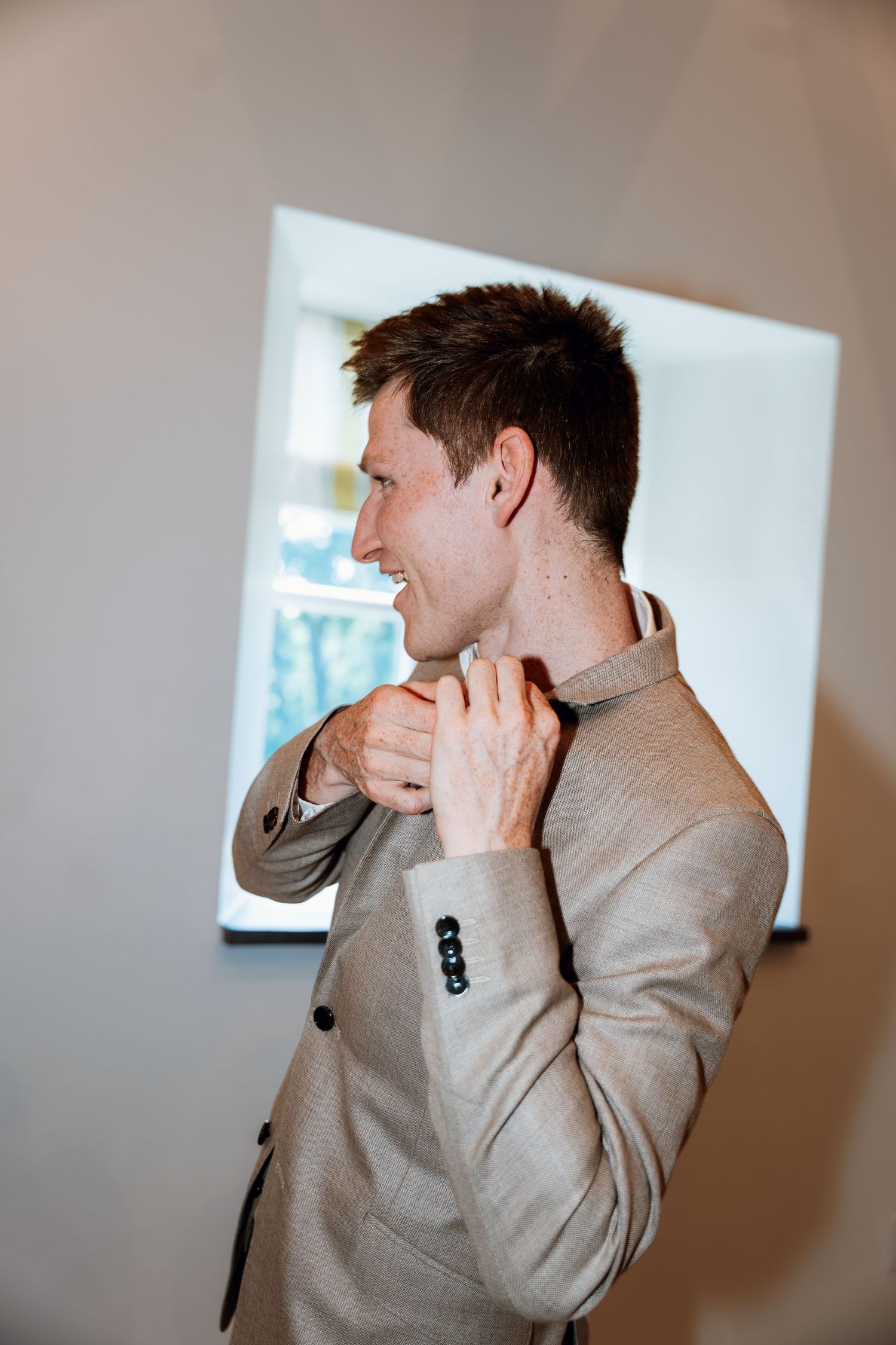 A series of candid shots showing someone in a gray suit jacket covering their face with their hand.
