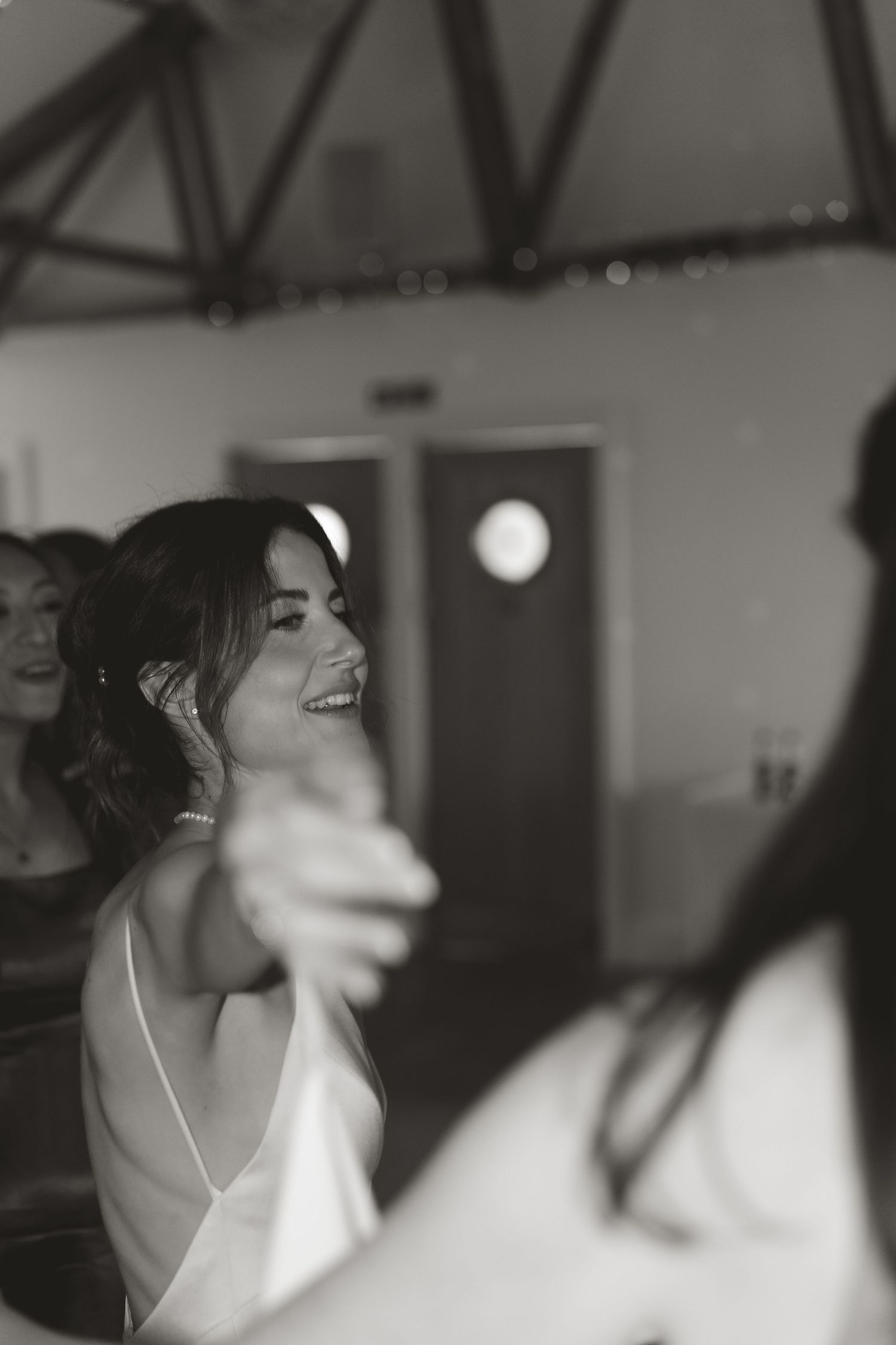 Black and white candid wedding reception photos showing joyful celebration moments.