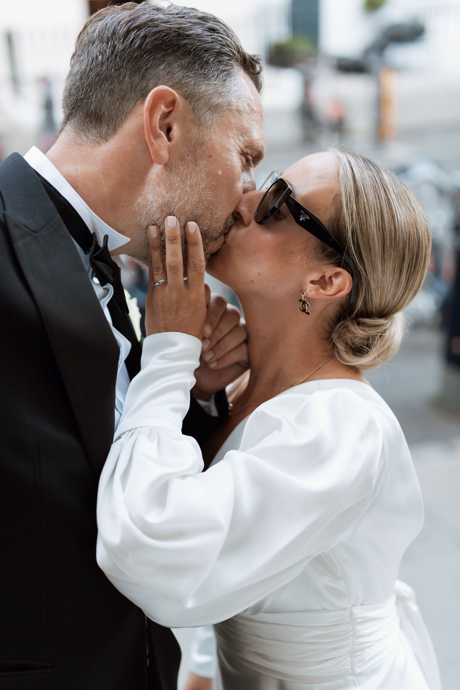 Couple in formal attire sharing intimate kisses in a romantic sequence.