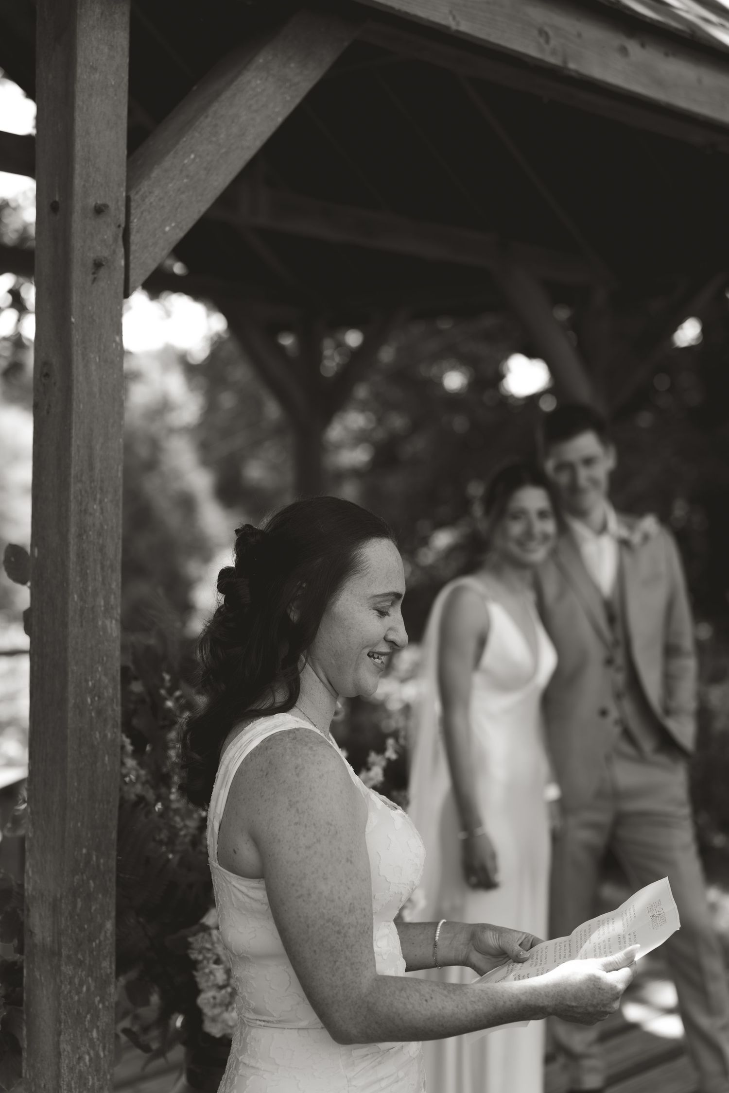 Black and white photo sequence of wedding ceremony moments under a wooden structure.