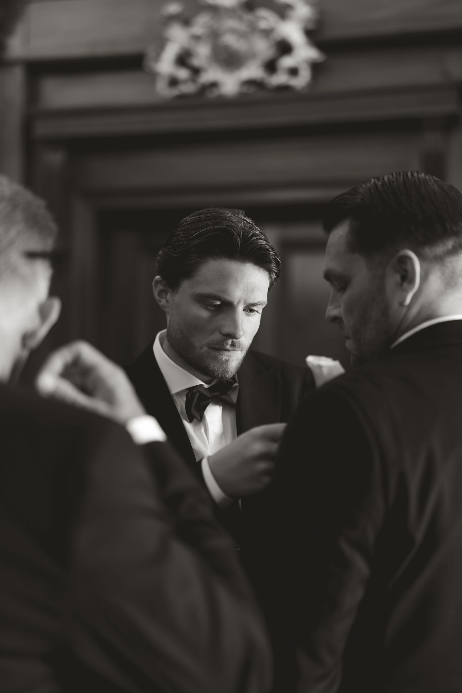 Black and white photo of guests in formal attire at an elegant event.