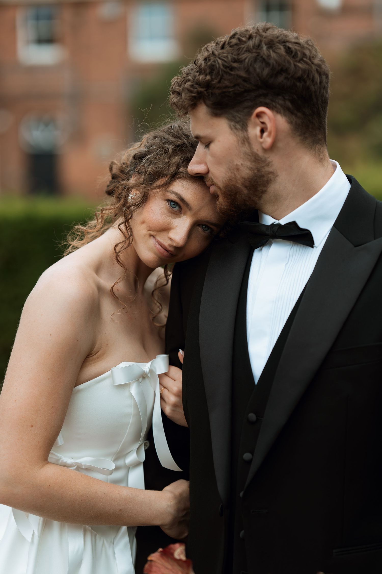 A romantic wedding portrait series showing tender moments between a bride in white and groom in black tuxedo.