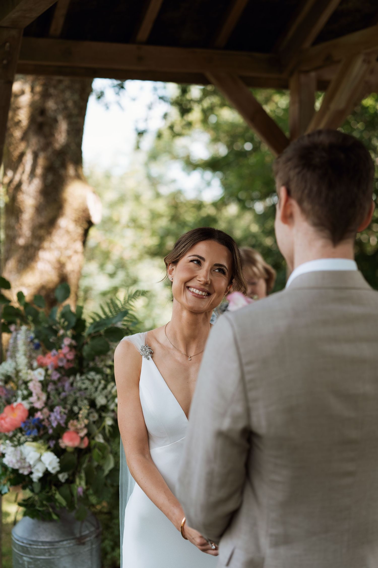 A joyful wedding moment captured in a series of candid shots showing a couple sharing laughter in an outdoor garden setting.