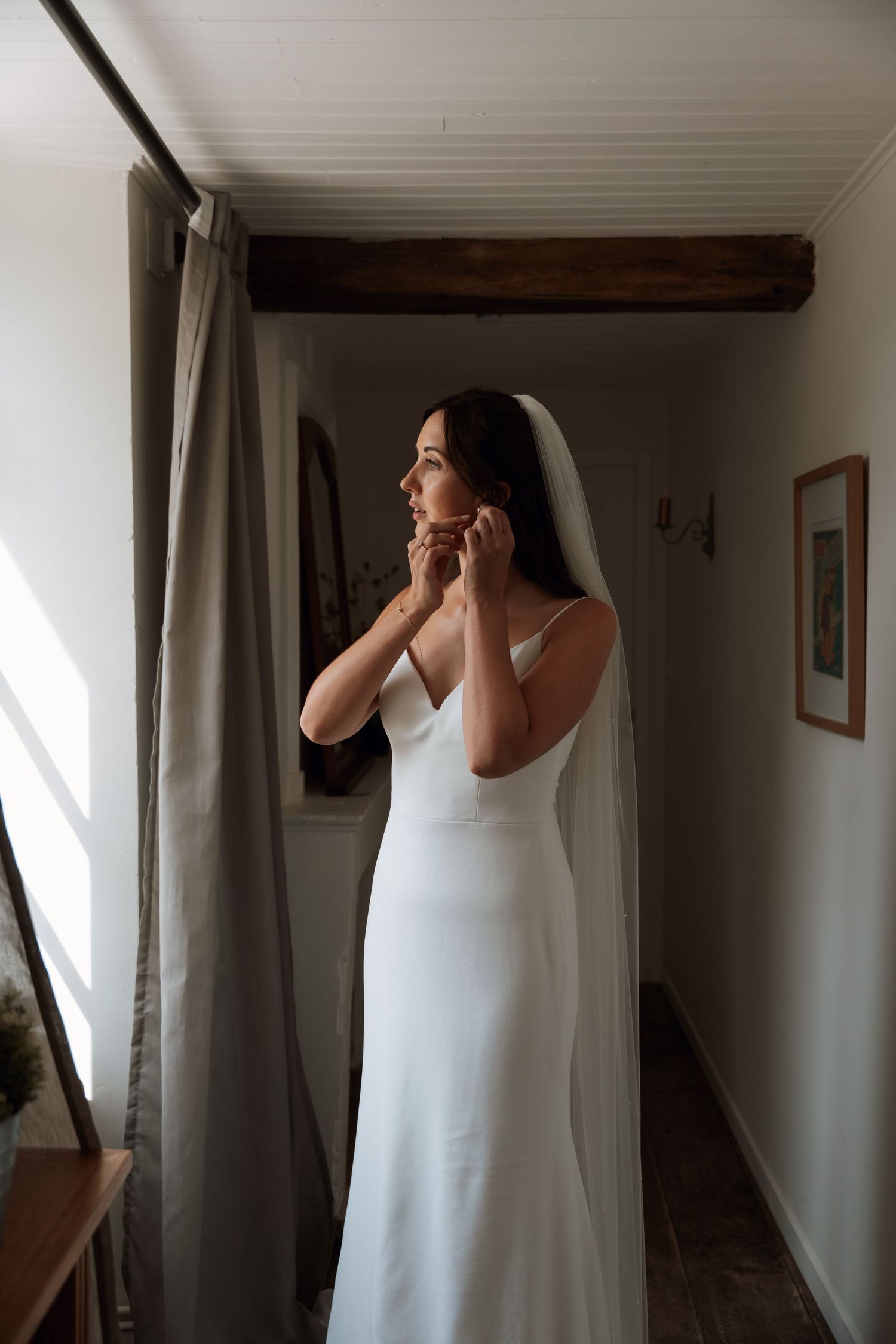A figure in a white dress stands by a window with curtains in a series of emotional getting-ready moments.