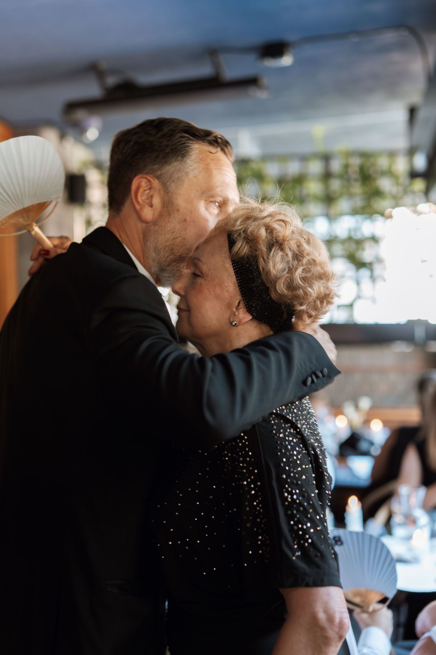 Couple dancing together at an indoor wedding reception.