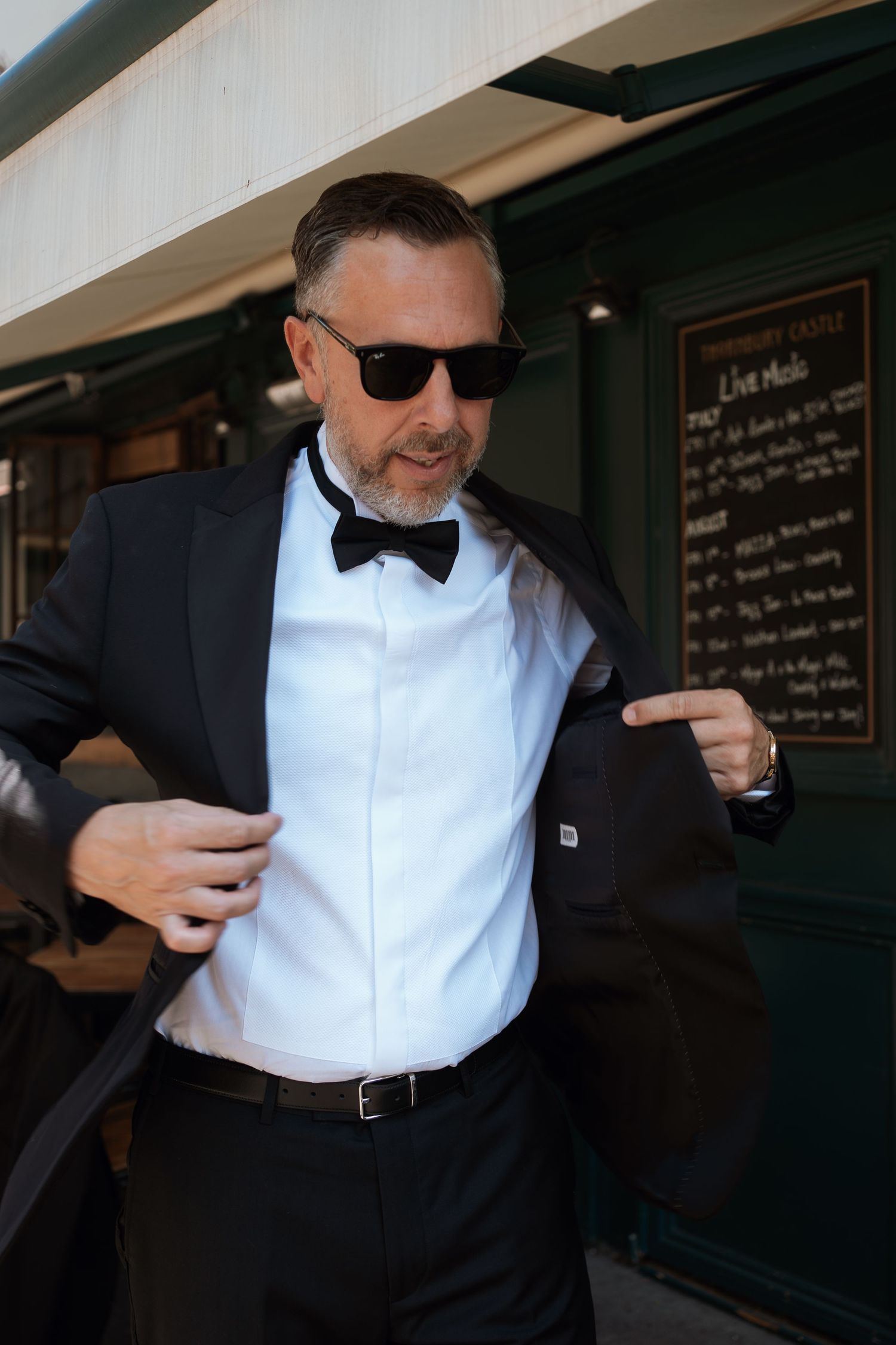 A person in formal attire wearing sunglasses and a bowtie gestures animatedly in a series of candid shots.