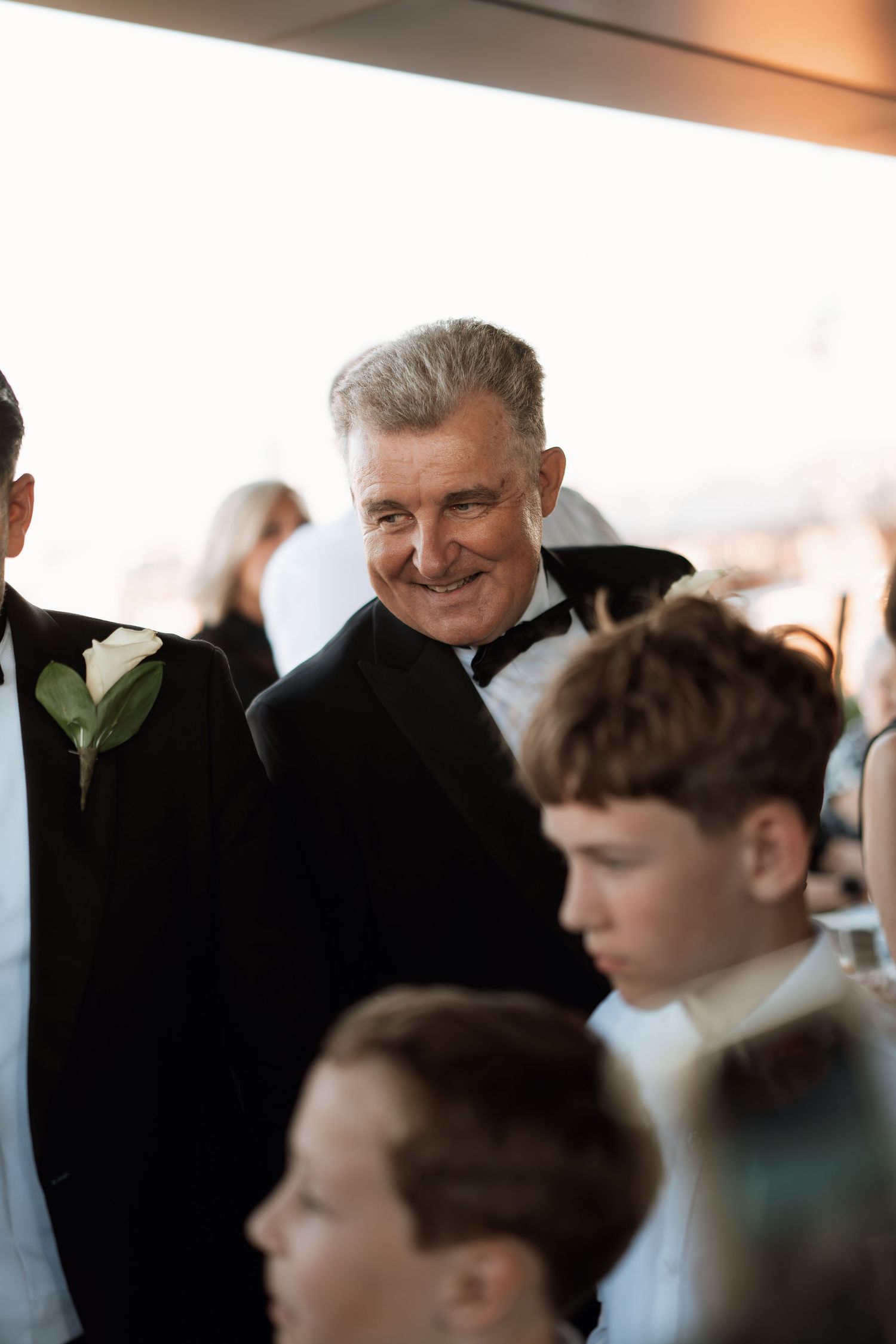Wedding guests chat and mingle during formal reception.