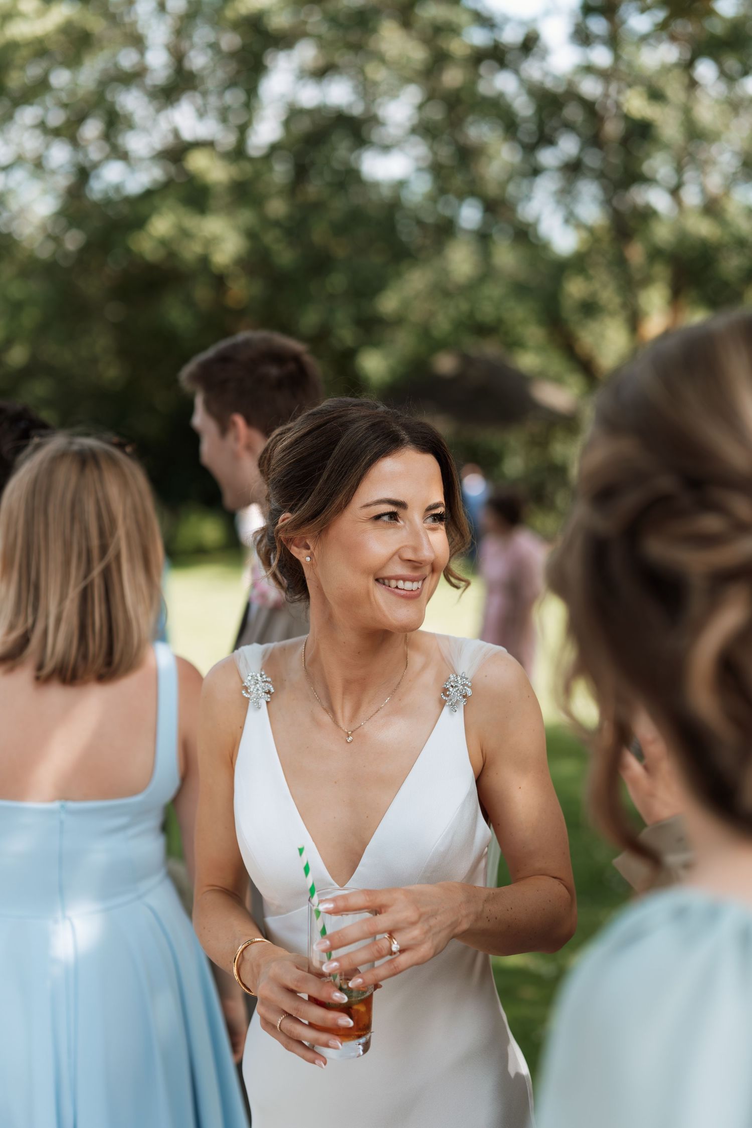 Elegant garden wedding reception with guests mingling outdoors.