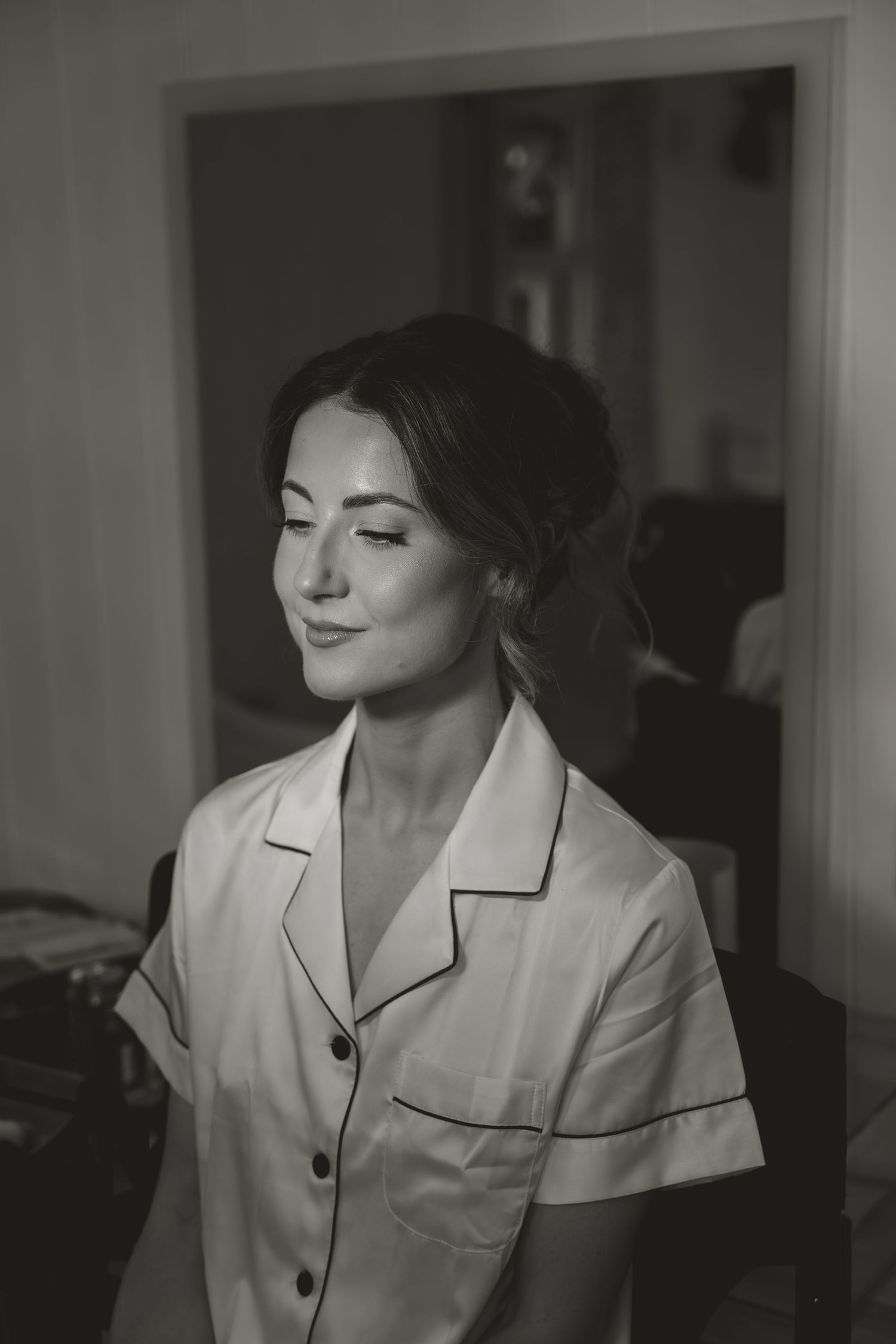 A series of black and white portraits showing someone in a white collared shirt with different expressions and poses.