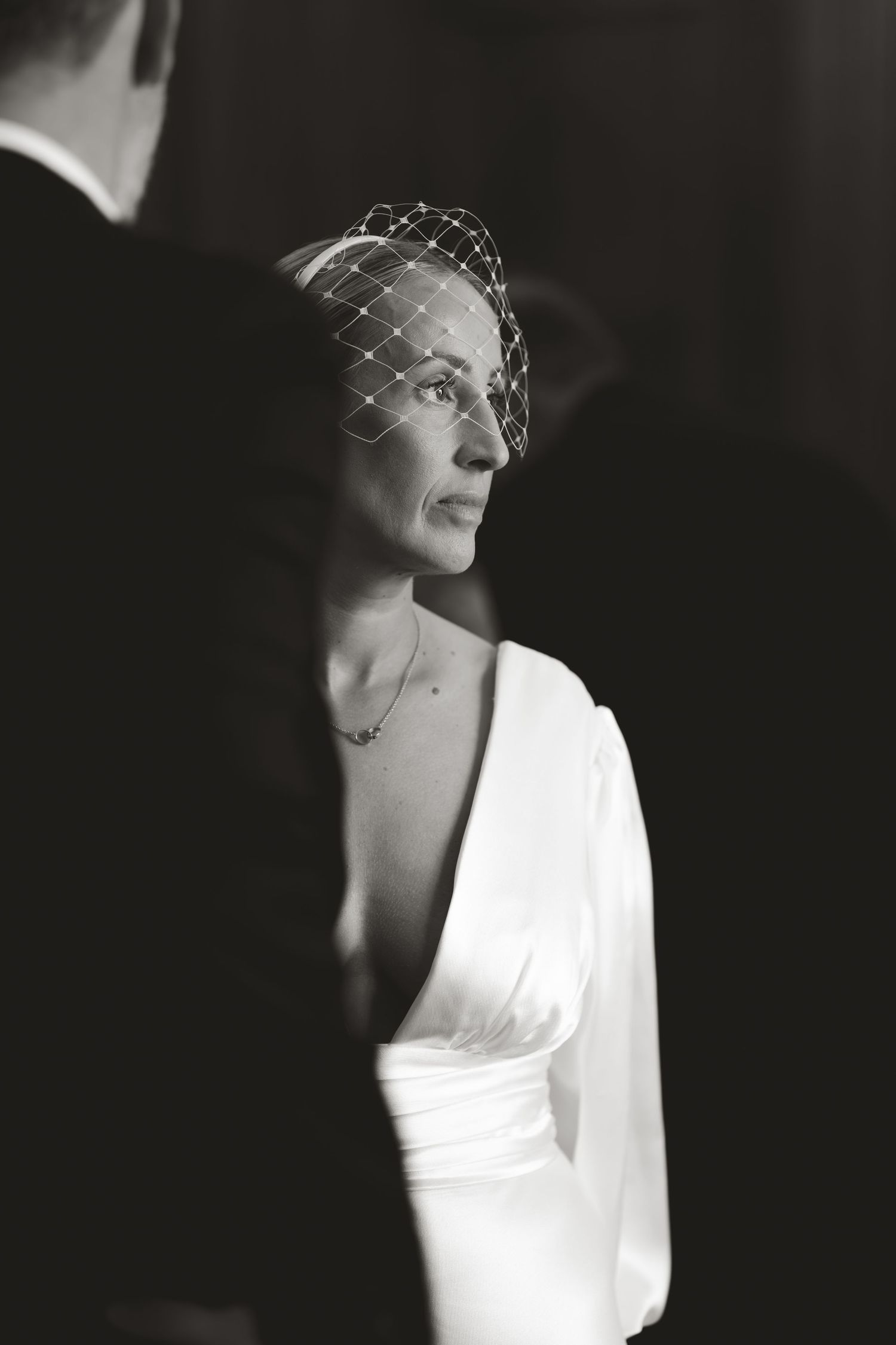 Black and white portrait of a bride wearing a vintage-style headpiece.