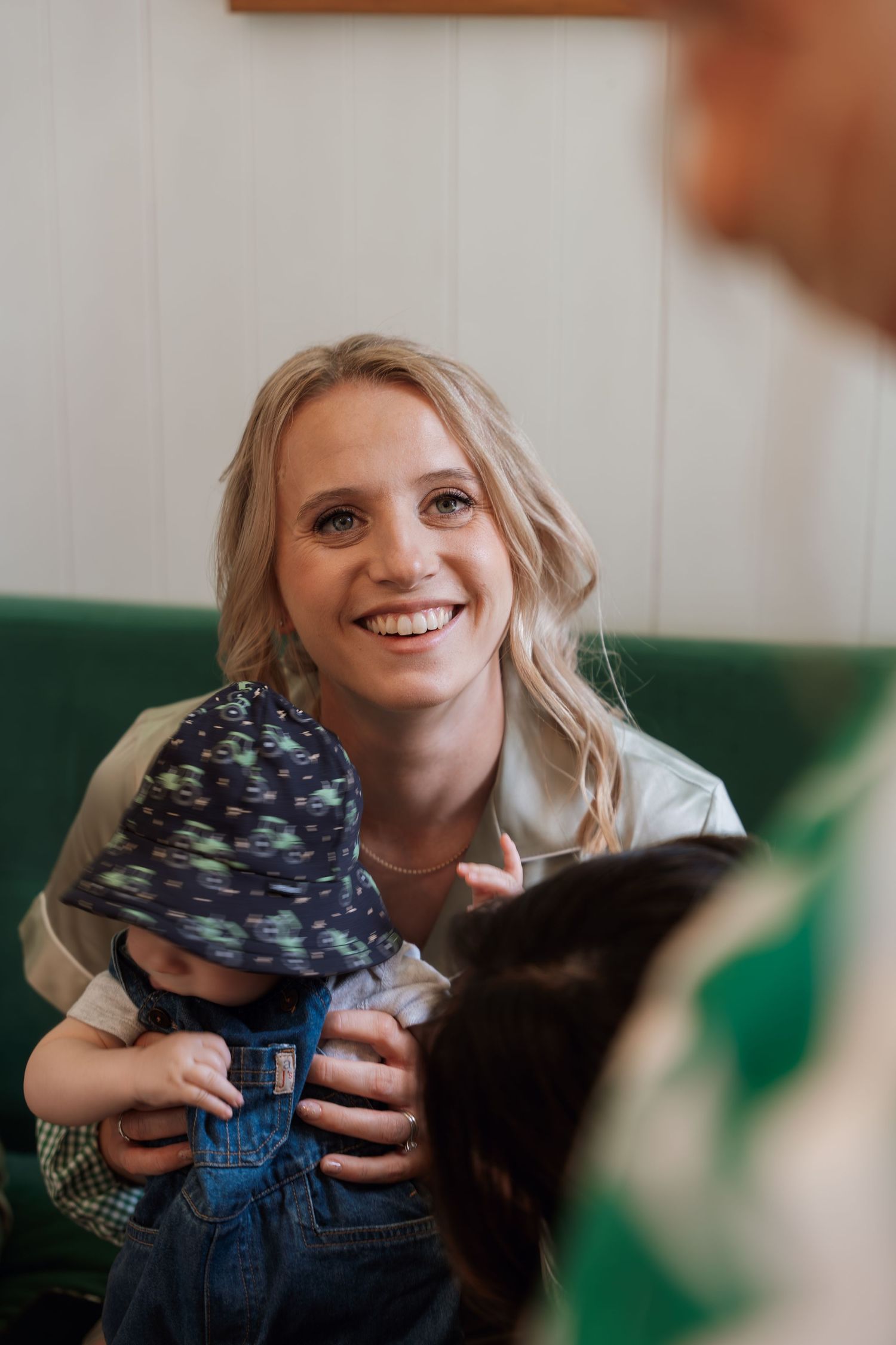 A series of candid shots showing someone holding and playing with a small cat in a casual indoor setting.