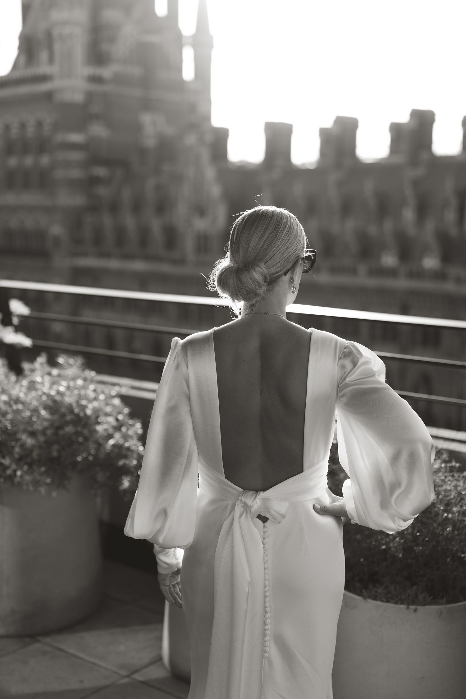 Artistic black and white photos showing the back of a wedding dress with button details.