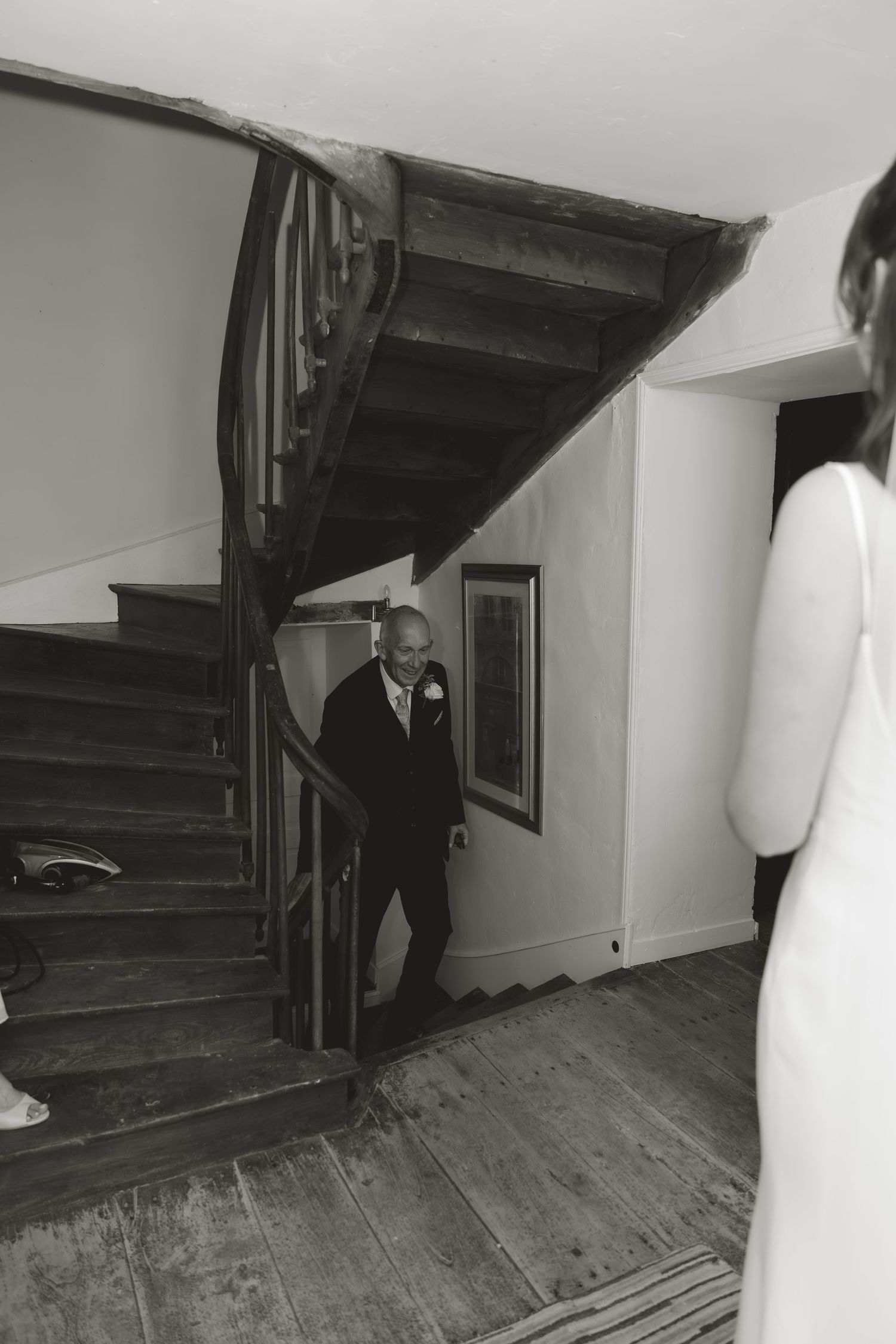 Black and white photo of a staircase in an old house.