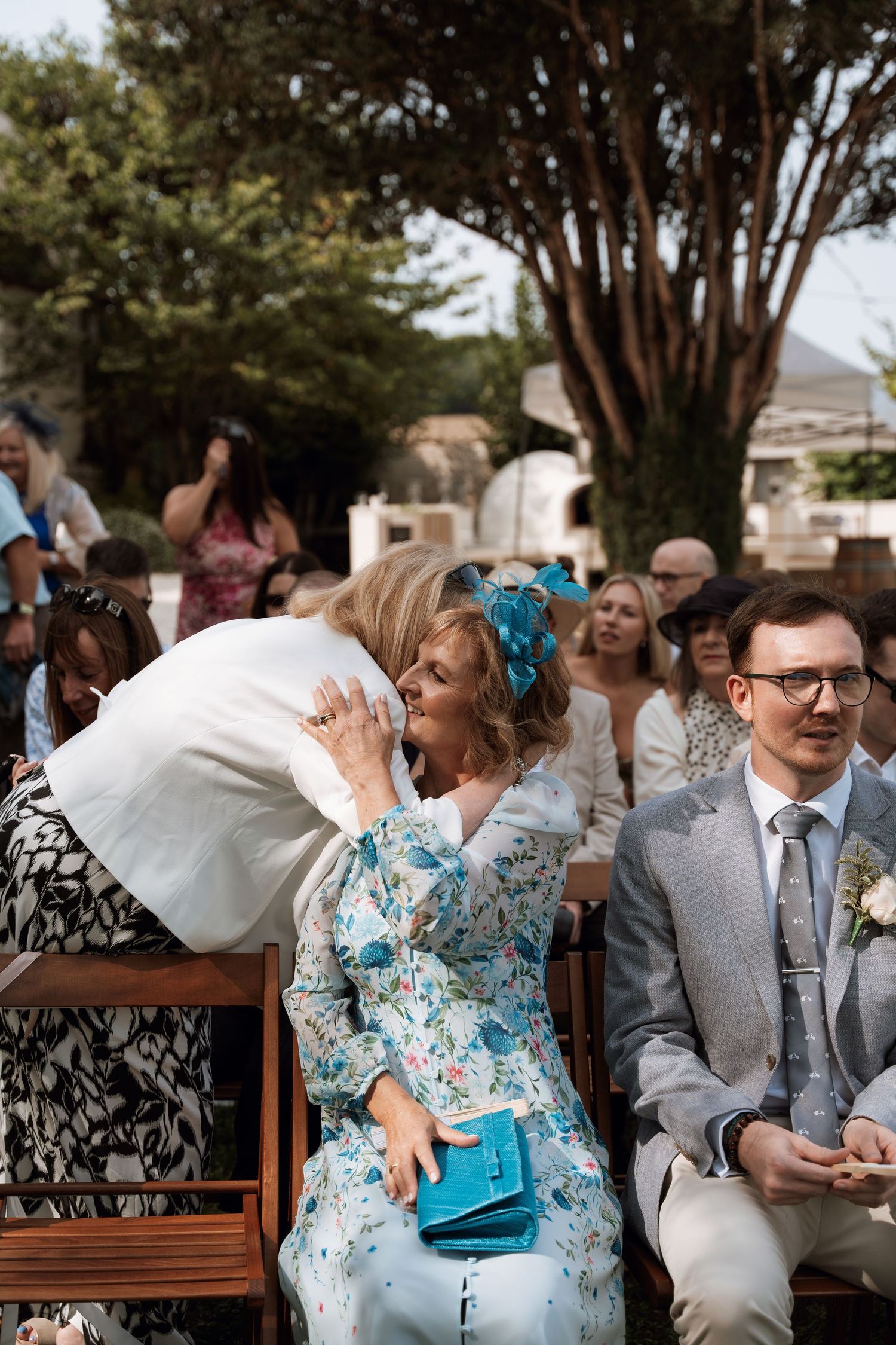 Wedding guests in summer attire enjoying an outdoor celebration.