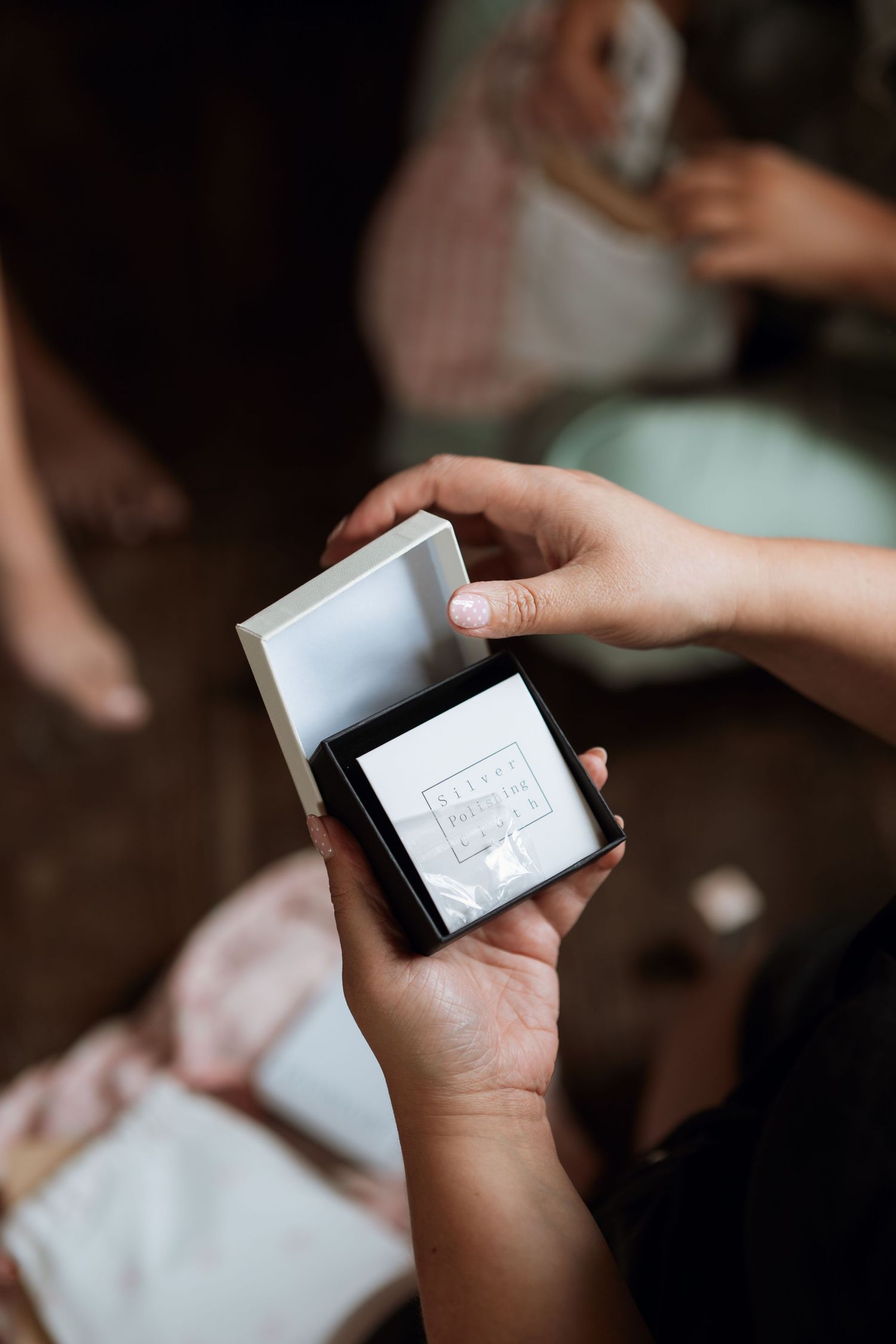Close-up shots of hands holding and exchanging small white cards.