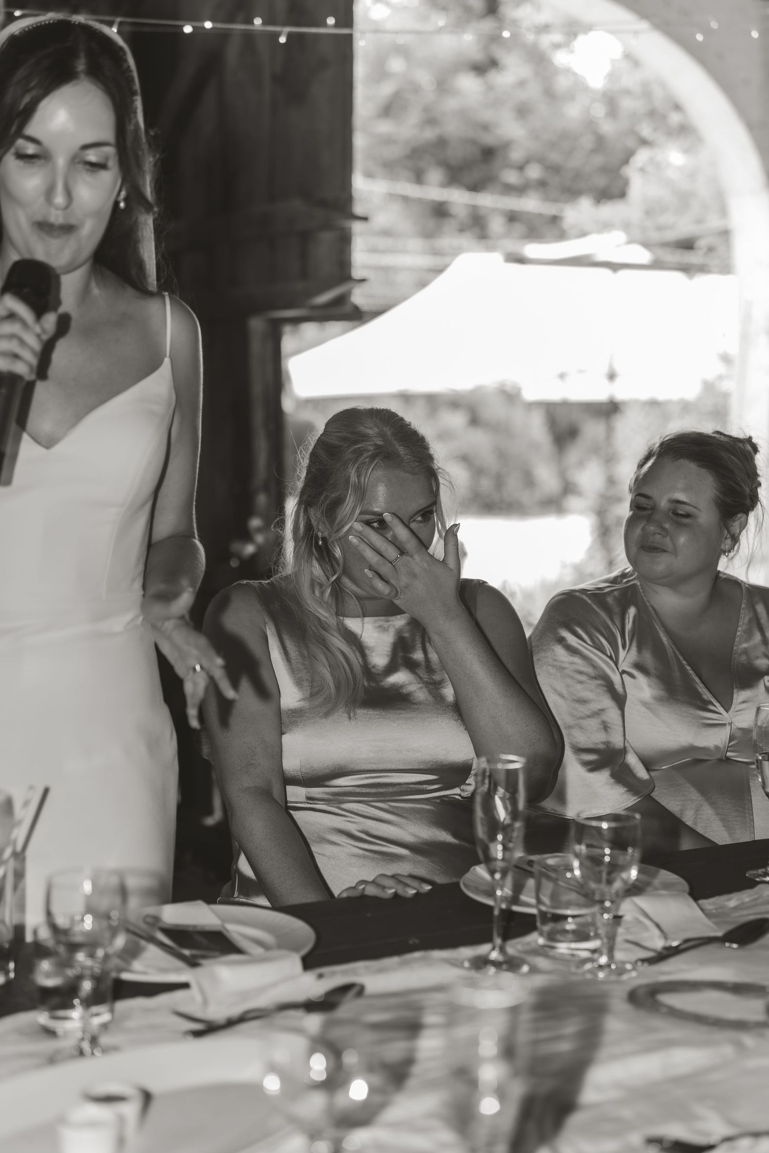 Black and white candid shots of wedding guests during reception dinner.