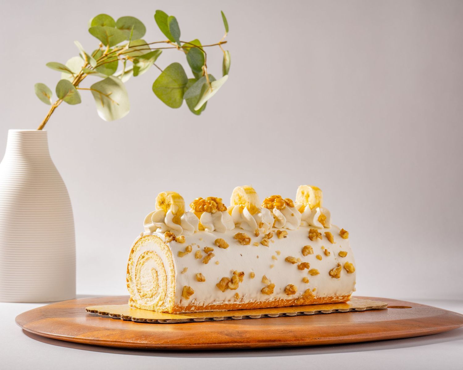 Cream-filled dessert roll cake photographed for bakery branding, menu photography, and promotional use.