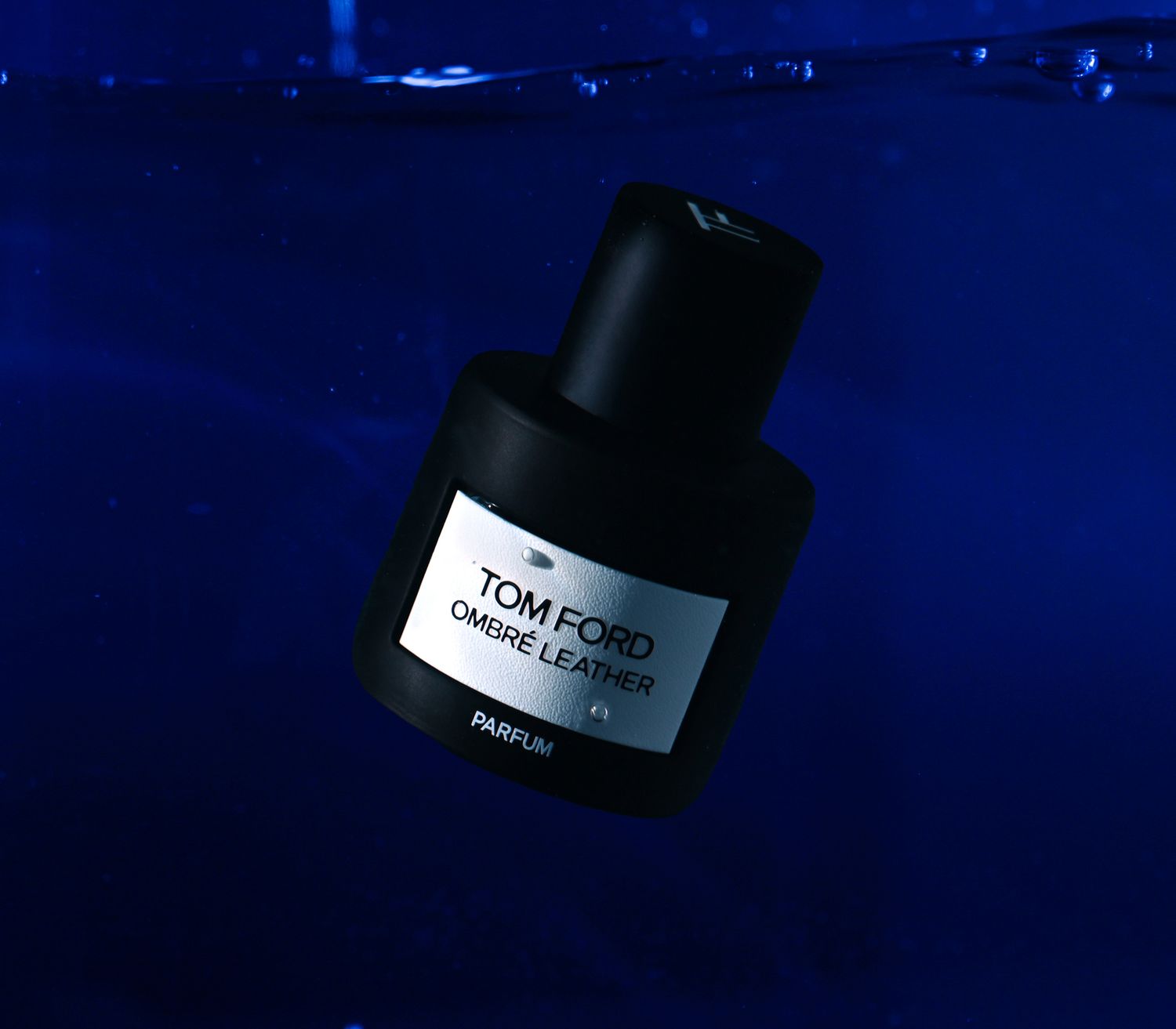 Tom Ford Ombré Leather Parfum submerged in water, photographed for bold, cinematic fragrance branding.