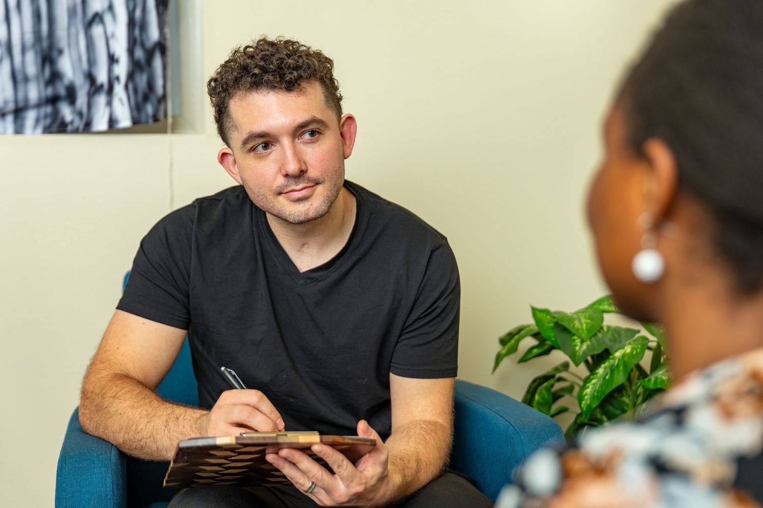 Professional portrait of therapist consulting with client, photographed for healthcare and counseling branding.
