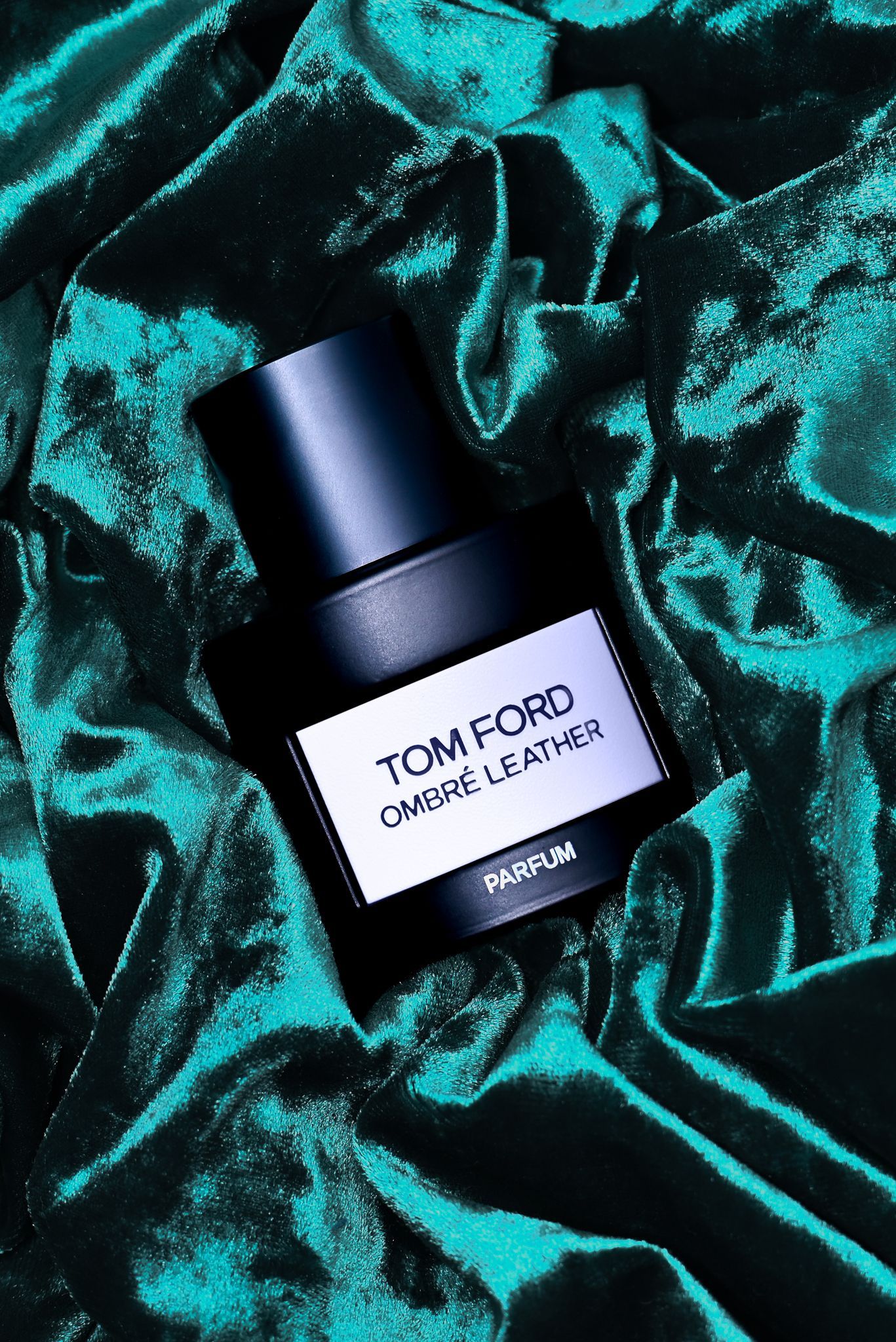Tom Ford Ombré Leather Parfum styled on textured velvet, photographed for luxury fragrance advertising.