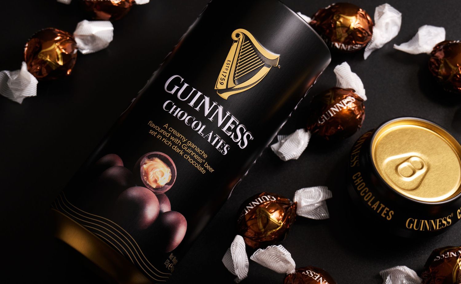 Guinness chocolate packaging and wrapped truffles styled in a flat lay for premium product and confectionery branding.